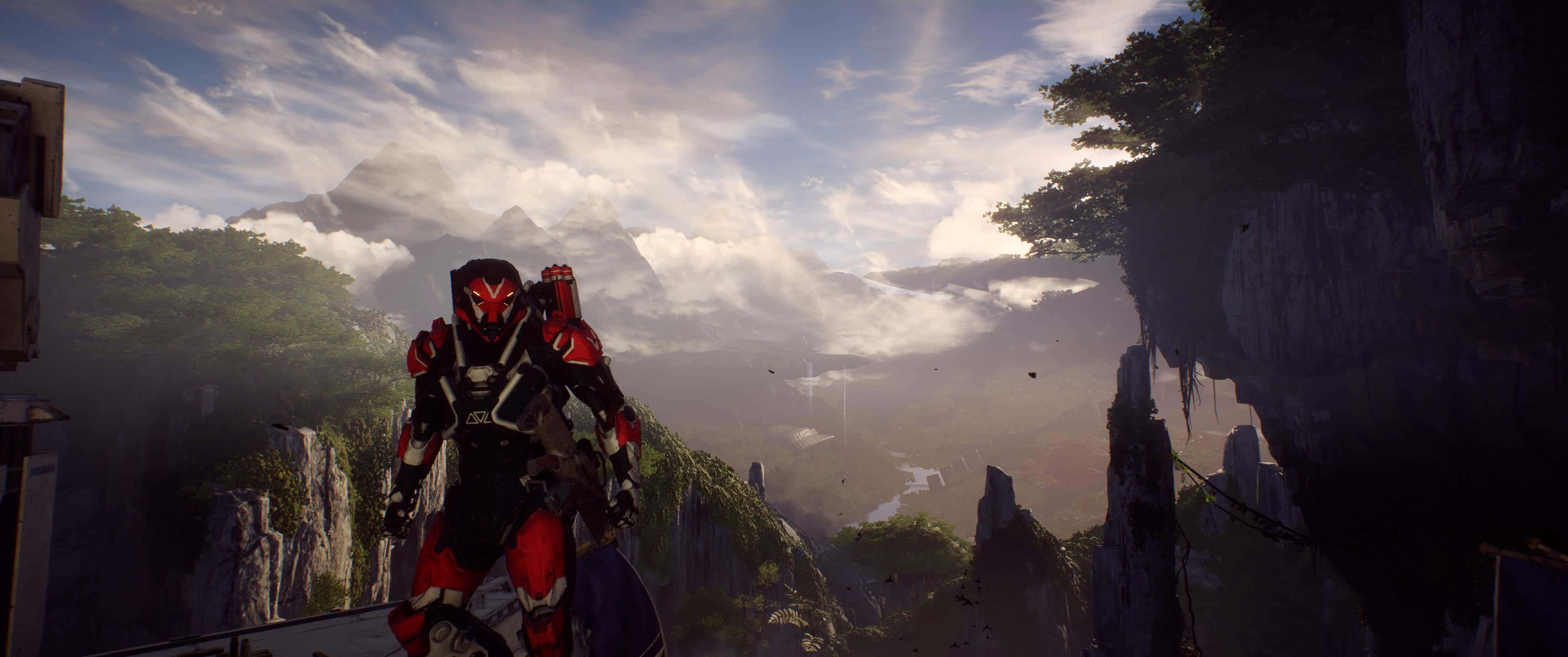 Anthem 遊戲角色 3440x1440p 背景 壁紙 — 一位身穿紅黑盔甲的戰士站在懸崖邊，俯瞰日出時霧氣繚繞的山谷。