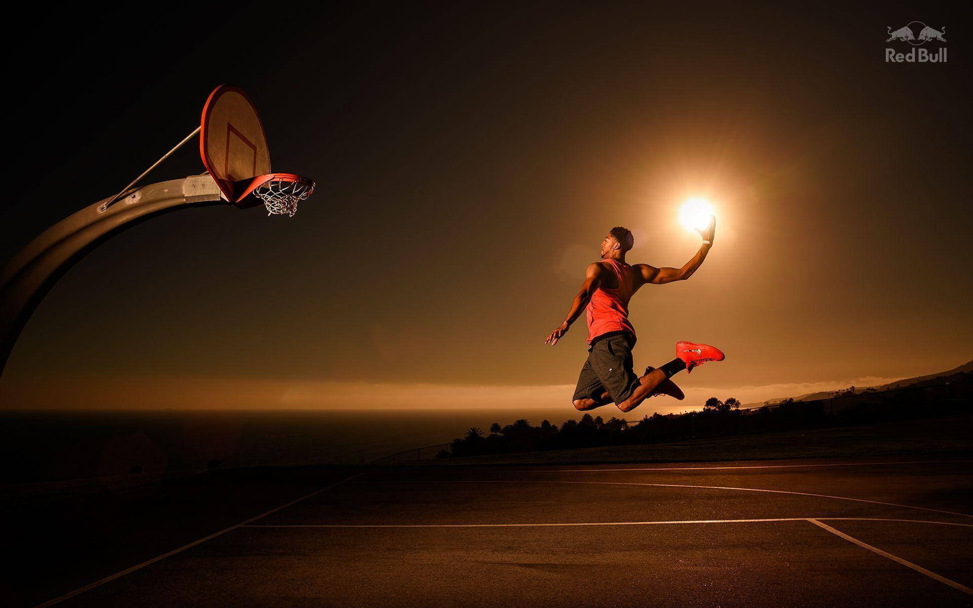 運動員在半空中拿著發光的球靠近籃框，夜間