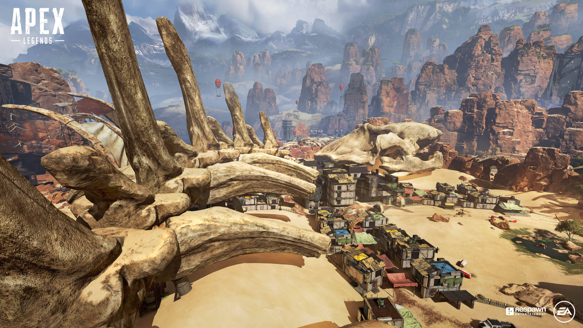 Apex Legends 4K 高清對決場景 壁紙 — 一個巨大的恐龍骨架聳立在一個峽谷中的沙漠小鎮上空，遠處是白雪覆蓋的山脈。