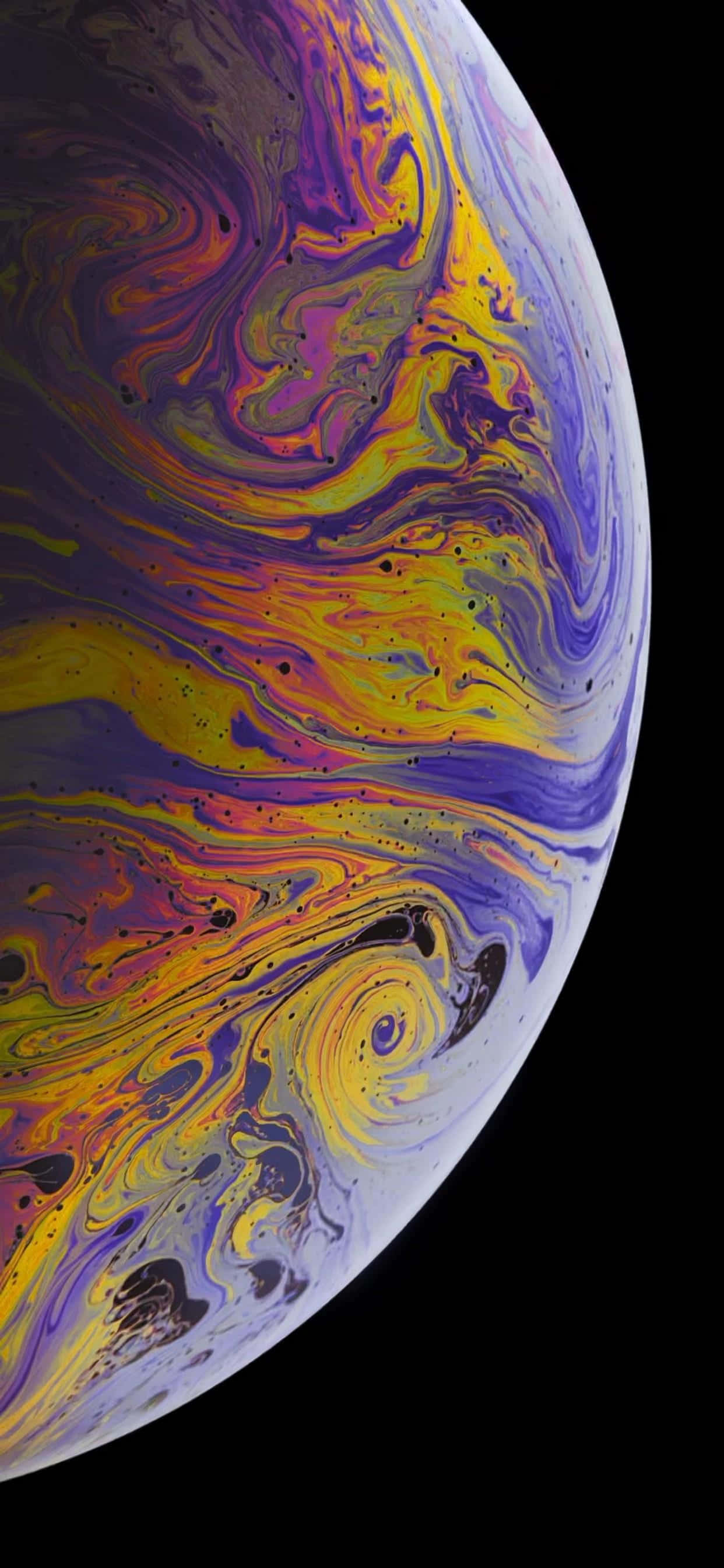 Apple iPhone XS Max紫黃星球 壁紙 — 一顆在黑色虛空中旋轉的行星，帶有鮮豔的紫色、黃色和橙色色調。