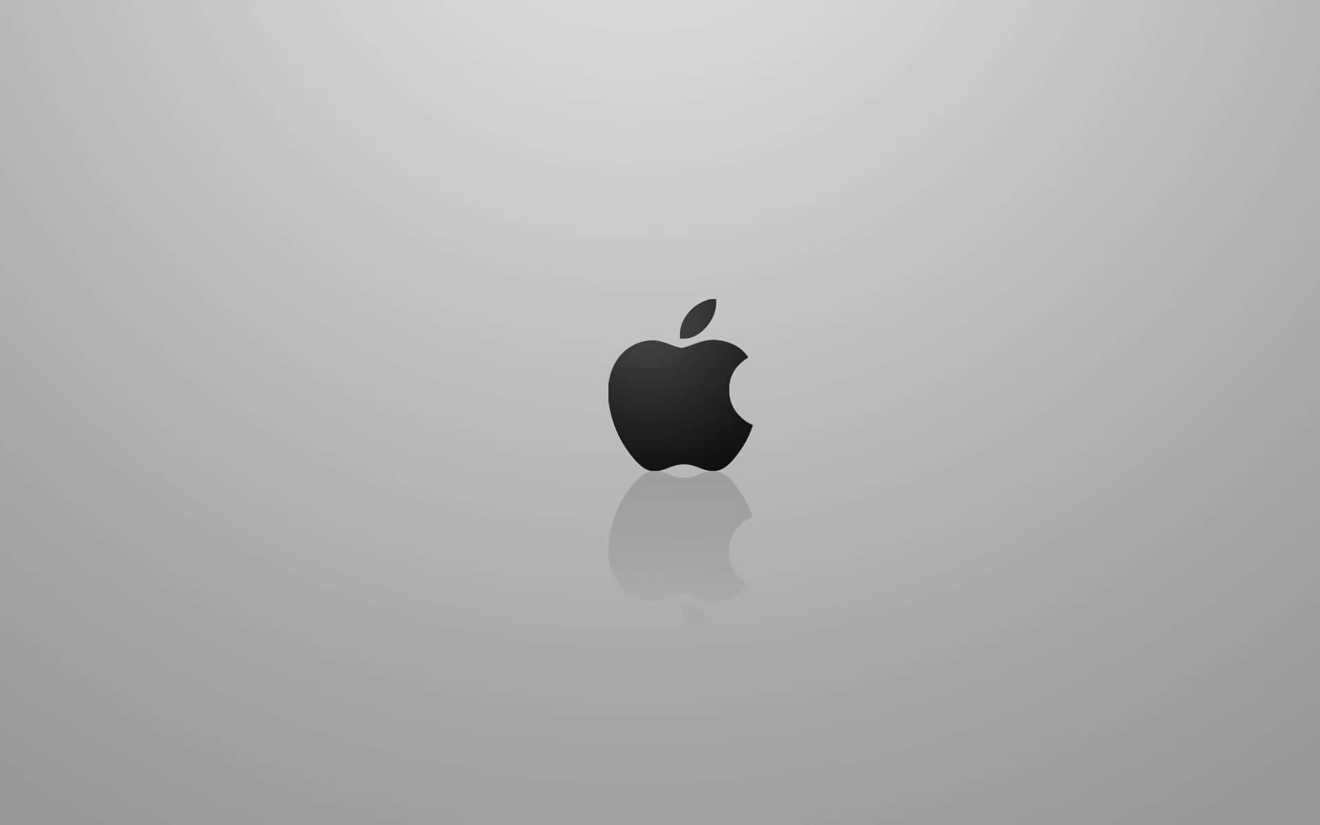 黑色Apple標誌帶倒影，置於灰色漸變背景上