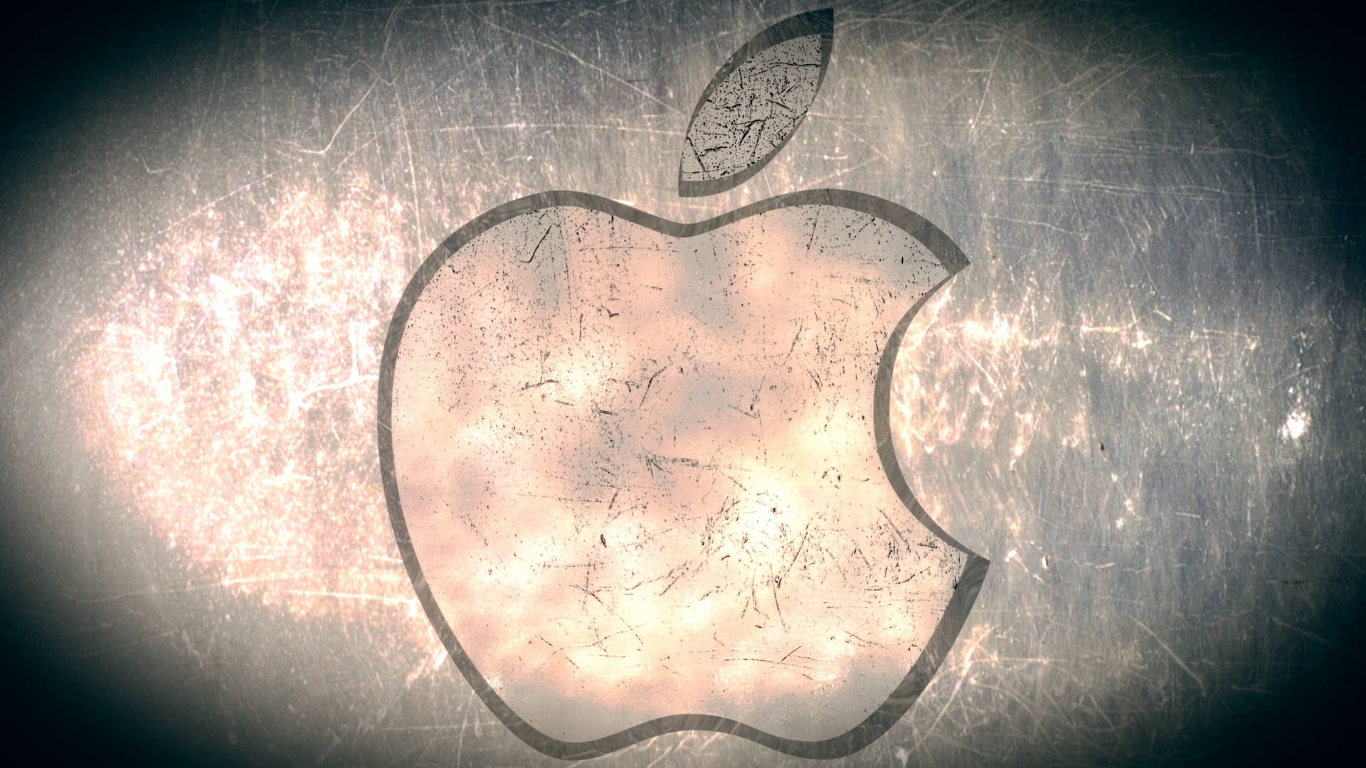 刮花金屬上的Apple標誌，中心發光，邊緣暗色。