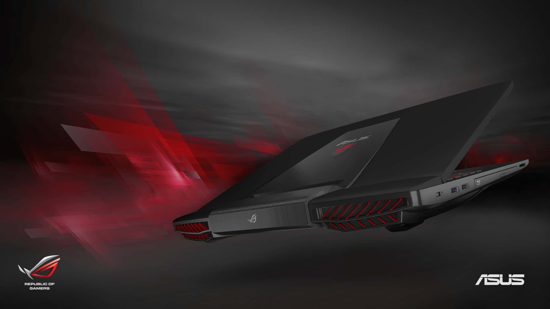 ASUS ROG 系列電腦，科技創新之核心 壁紙 — 一部時尚的黑色ASUS ROG電競手提電腦，帶有紅色點綴，在黑暗的抽象空間中滑行，留下發光的紅色動態軌跡。