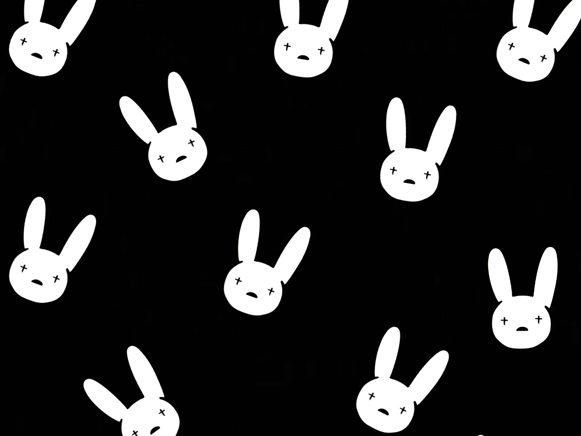Bad Bunny 白色簡約兔頭標誌 壁紙 — 白色極簡兔頭帶有X形眼睛，以散落圖案漂浮在純黑色背景上。