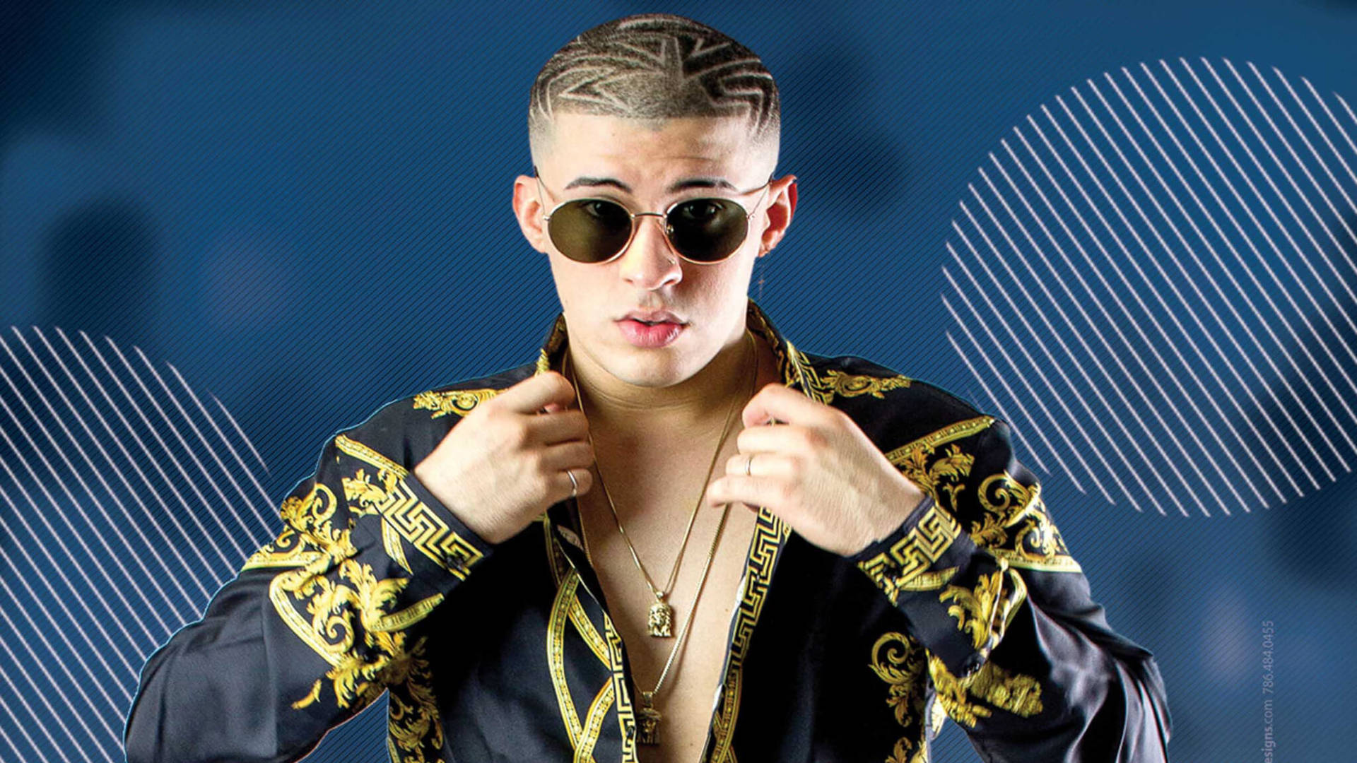 Bad Bunny 黑金Polo衫 壁紙 — 一位時尚男士，擁有幾何髮型和金色太陽眼鏡，在藍色圖案背景前調整他華麗的黑金外套。