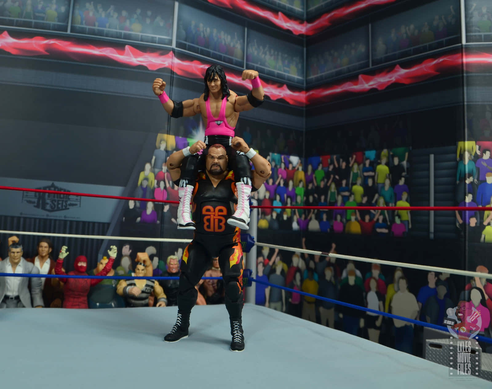 Bam Bam Bigelow WWE Bret Hart 1993 招牌造型 壁紙 — 兩個摔角手人偶在擂台上，一個被舉在肩上，兩者都在歡呼的人群前擺出勝利姿勢。