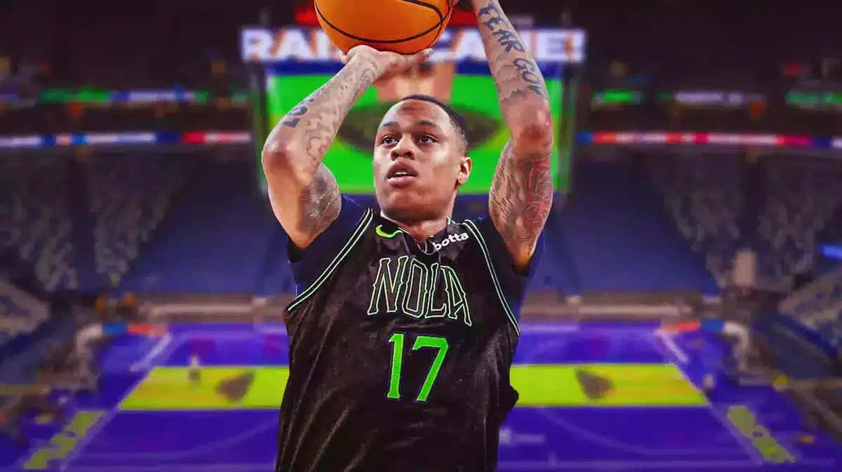  壁紙 — 一名穿著黑色 'NOLA 17' 球衣的籃球運動員在一個燈光璀璨、帶有紫色和綠色場地標記的體育館中投籃。