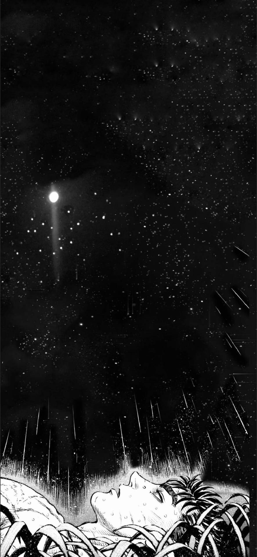 躺在草地上仰望夜空中彗星的人。
