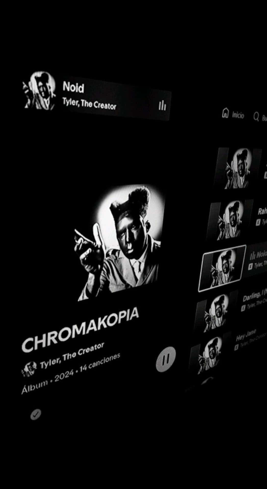  壁紙 — 黑白智能手機螢幕顯示 Tyler The Creator 的專輯 Chromakopia，附有藝術家肖像和曲目列表。