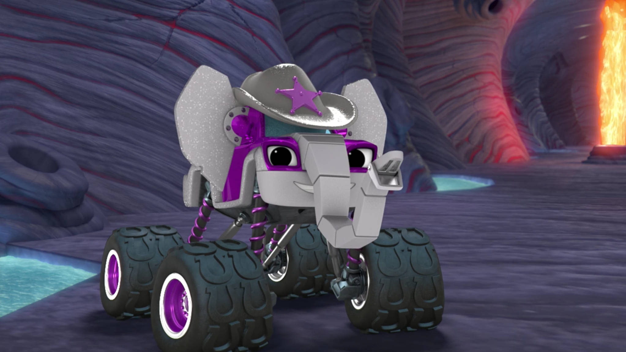 Blaze And The Monster Machines 象形機器人 壁紙 — 一輛紫色和銀色、具有大象特徵的怪獸卡車戴著牛仔帽，站在一個背景有熔岩的岩石洞穴中。