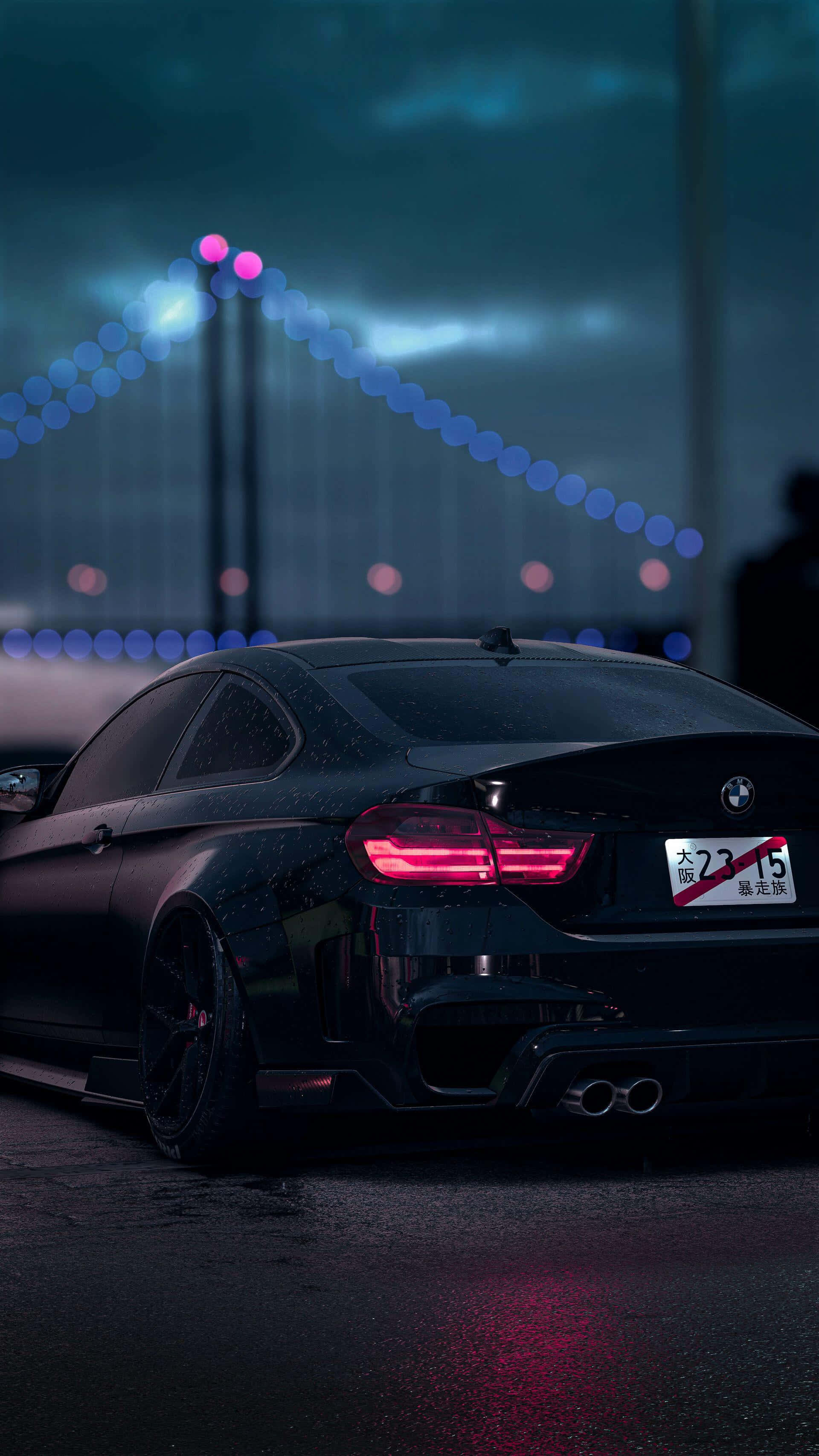 BMW 黑色車身對橋夜景背景 壁紙 — 一輛時尚的黑色跑車在雨夜中於霓虹燈下閃耀，背景是一座模糊的橋樑。