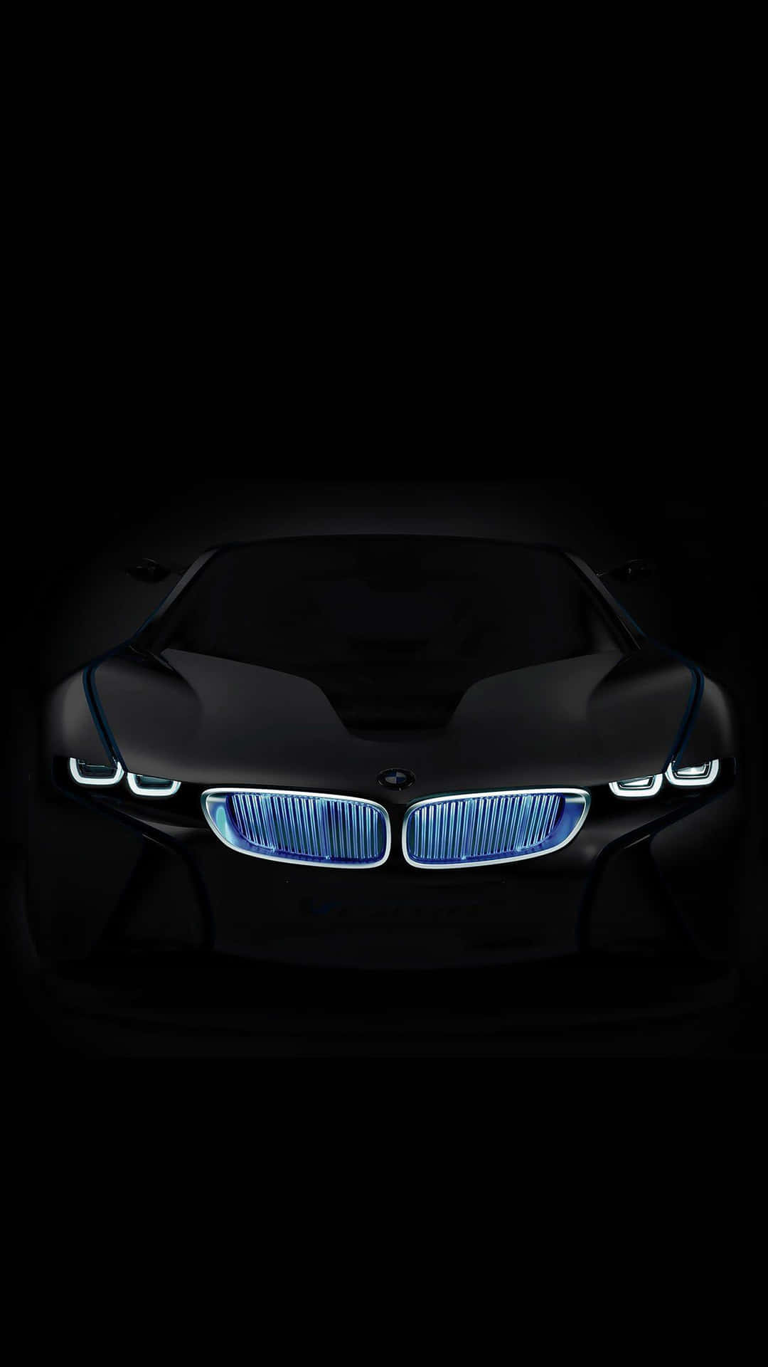 黑色BMW概念車在黑暗中帶有發光藍色車頭燈的前視圖。