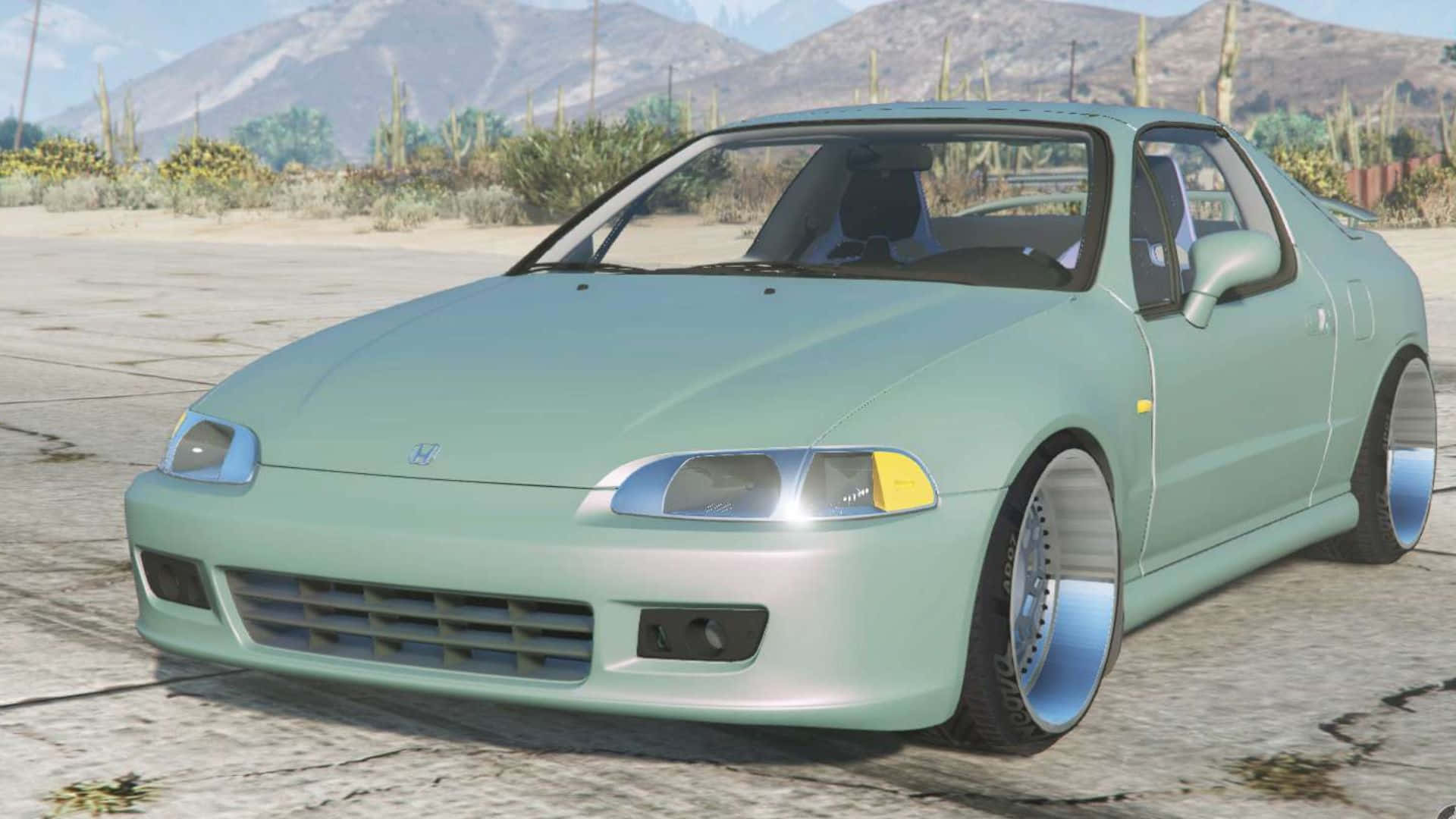 Honda Civic Del Sol 桌布 壁紙 — 一輛薄荷綠色的本田S2000跑車配備定制輪圈，停在裂開的路面上，背景是沙漠景觀，有山脈和仙人掌。