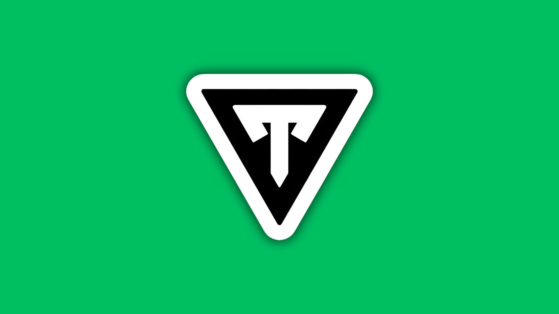  壁紙 — 一個大膽的黑色三角形標誌，內有白色「T」，置於鮮綠色背景上。