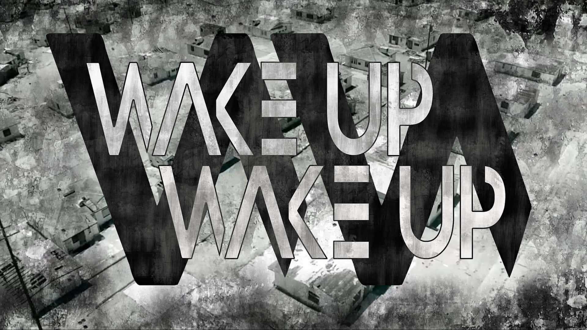  壁紙 — 大膽的金屬 'WAKE UP' 文字籠罩在單色衰敗城市景觀的粗糙航拍視圖上。