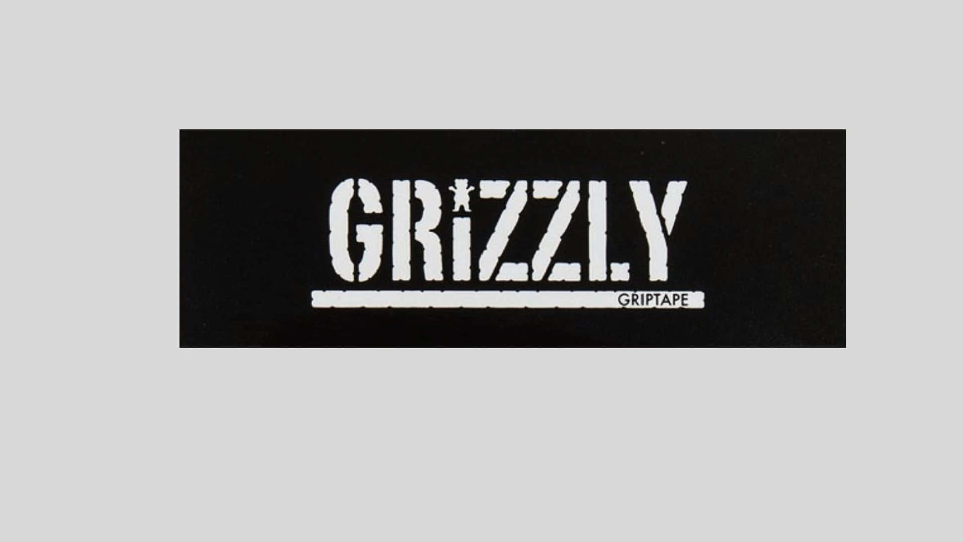  壁紙 — 黑色長方形背景上，粗體白色 'GRIZZLY' 標誌，'i' 上方有星號，下方有 'GRIPTAPE'。