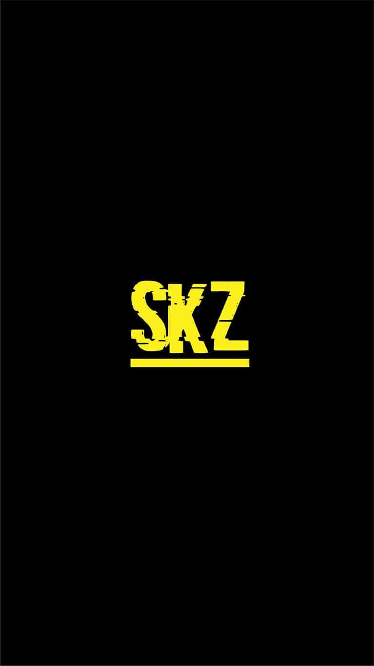  壁紙 — 在純黑色背景中央放置的帶有磨損紋理的醒目黃色SKZ標誌。