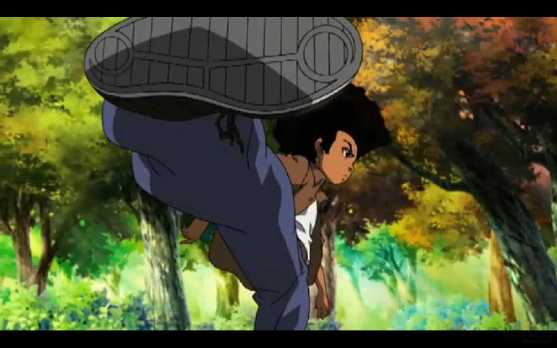 《Boondocks》胡伊踢腿 壁紙 — 一個動漫角色在陽光明媚的森林中，以鮮豔的秋葉為背景，表演高踢腿。