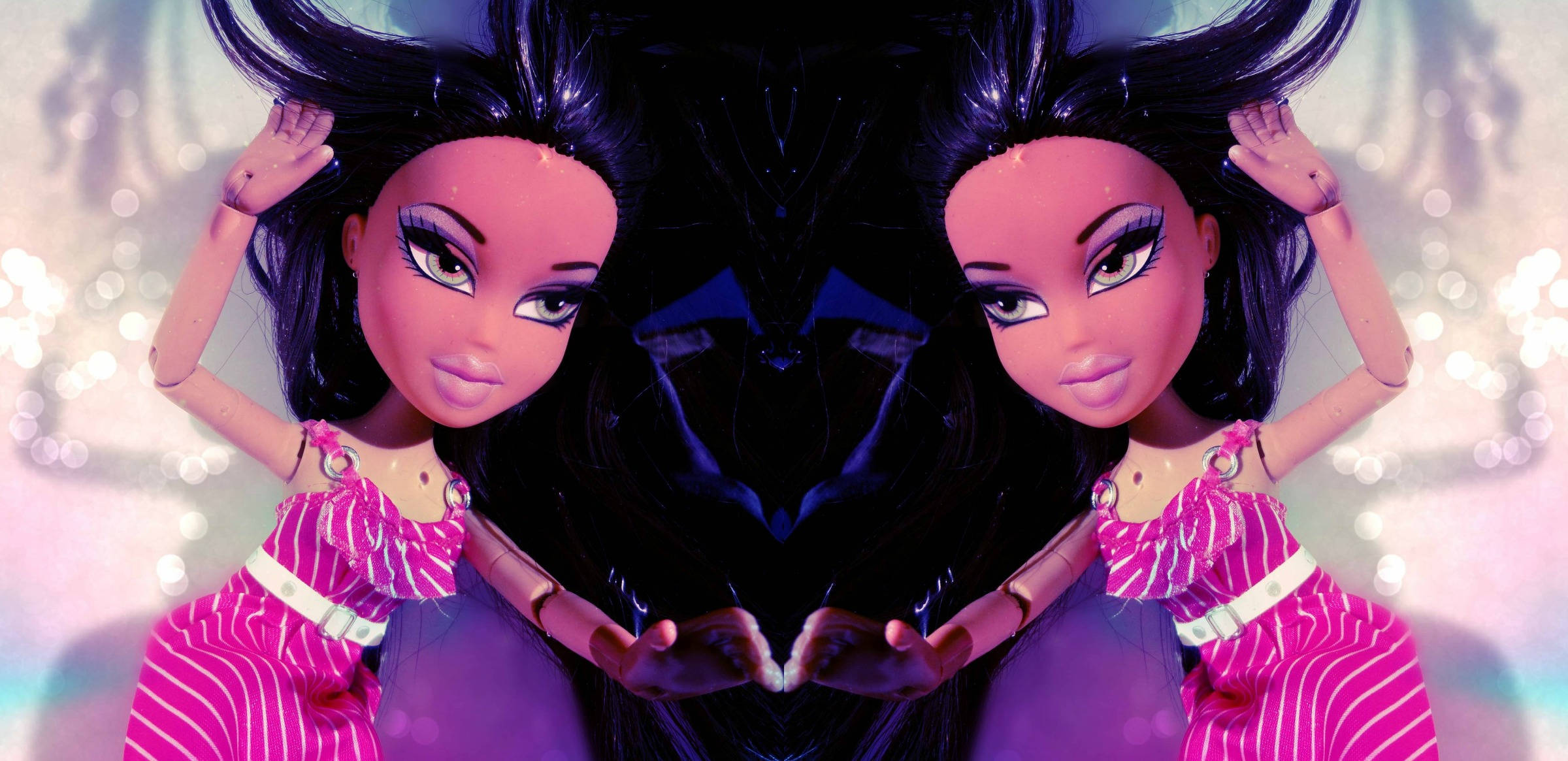Bratz 風格玩偶穿粉紅洋裝 壁紙 — 兩個鏡像的 Bratz 公仔穿著粉紅色條紋連衣裙，舉起雙手在閃爍的散景背景前擺姿勢。