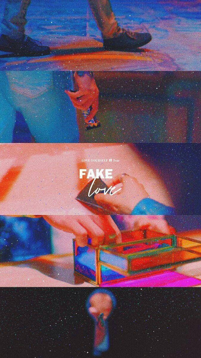 手在宇宙和城市背景下排列彩色玻璃物體，帶有「FAKE love」文字。