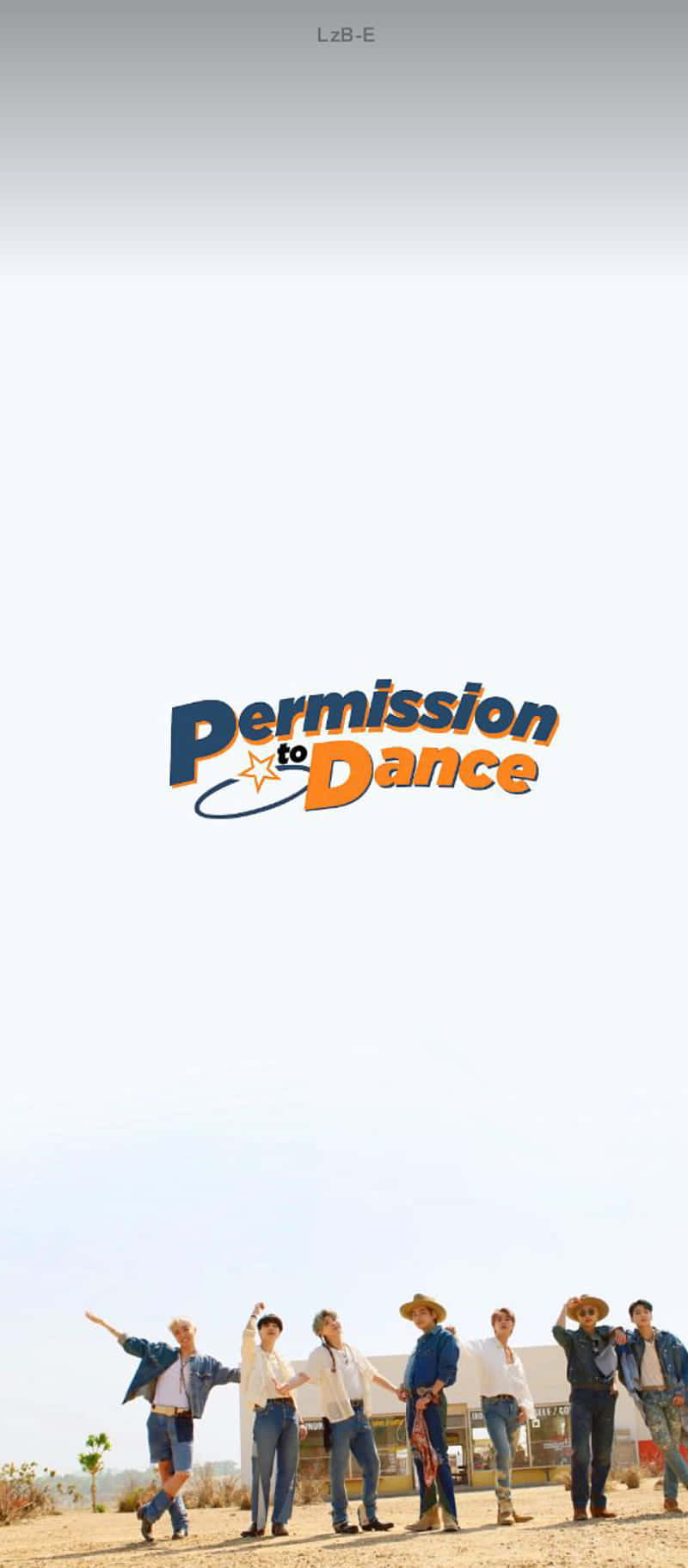 七名男子在沙漠中跳舞，帶有 'Permission to Dance' 標誌。