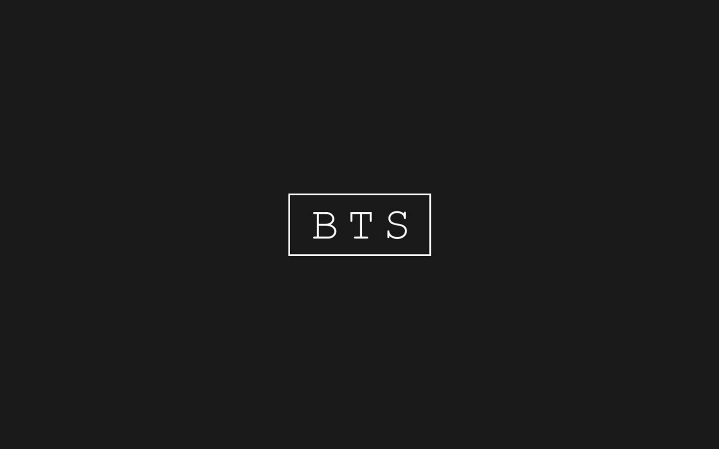 黑色背景，白色邊框的BTS文字居中。