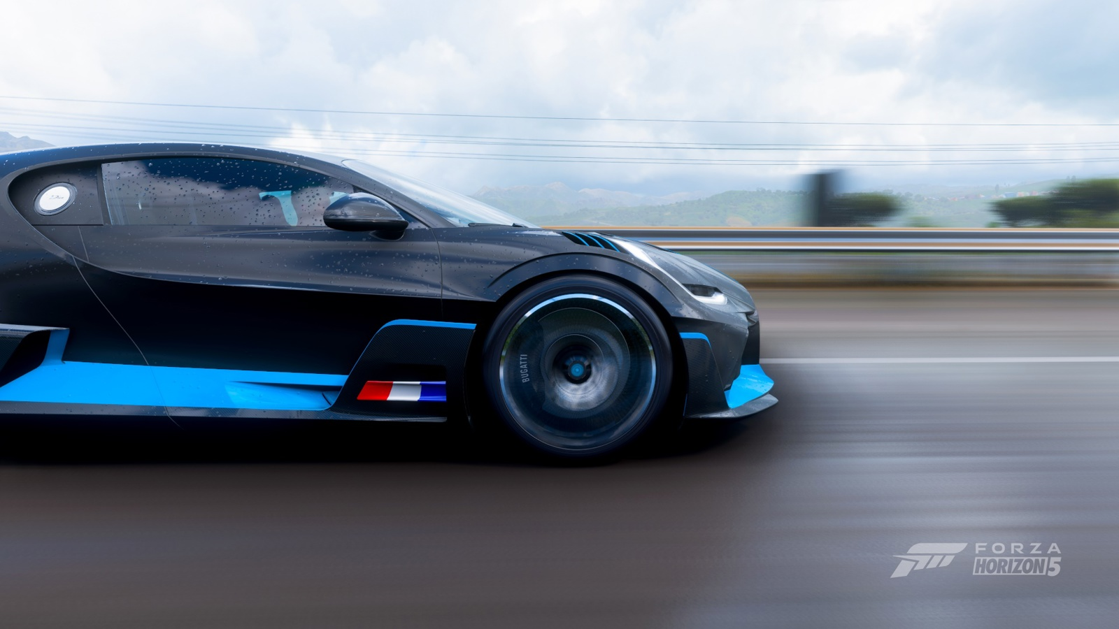 Bugatti Forza 5 壁紙 — 一輛時尚的黑色跑車帶有藍色點綴，在陰天的高速公路上疾馳，背景模糊。
