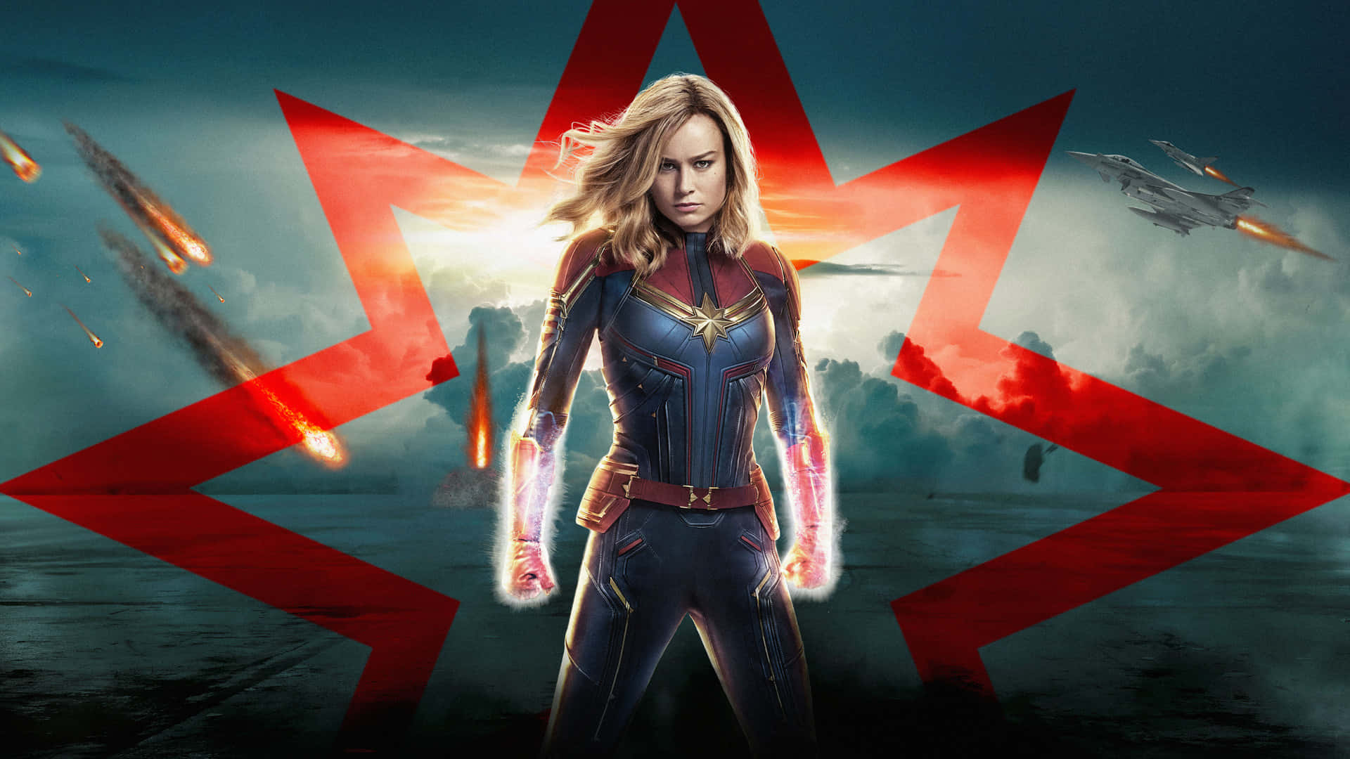 Captain Marvel HD 桌布 壁紙 — Captain Marvel 英雄地站在暴風雨的天空下，紅色能量光束和飛行的噴射機在她周圍爆炸。