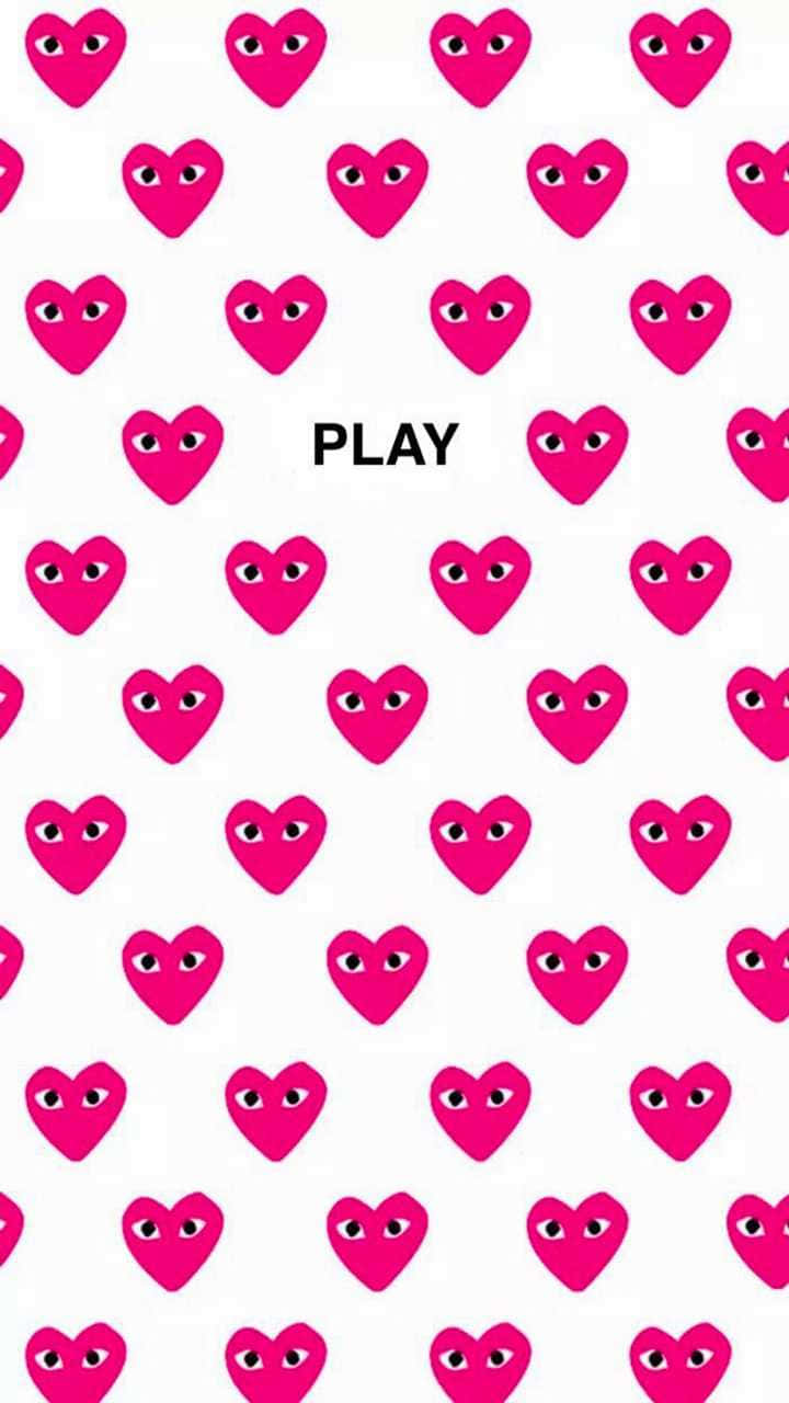 白色背景上帶有眼睛的粉紅色心形和 play 字樣