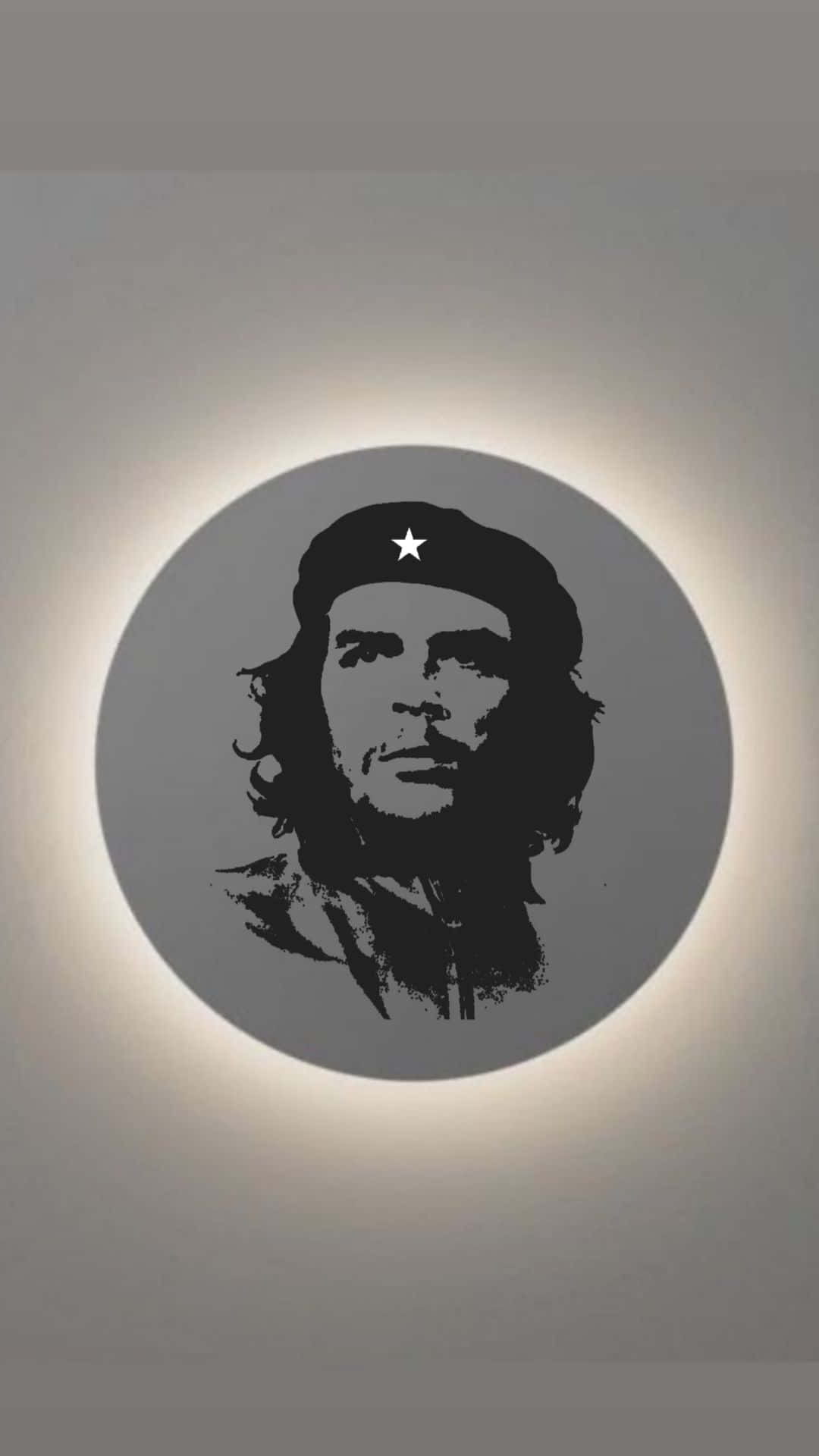  壁紙 — 一個圓圈內切·格瓦拉臉部的鮮明黑色剪影，在柔和背光照射下，映襯著柔和的灰色牆壁。