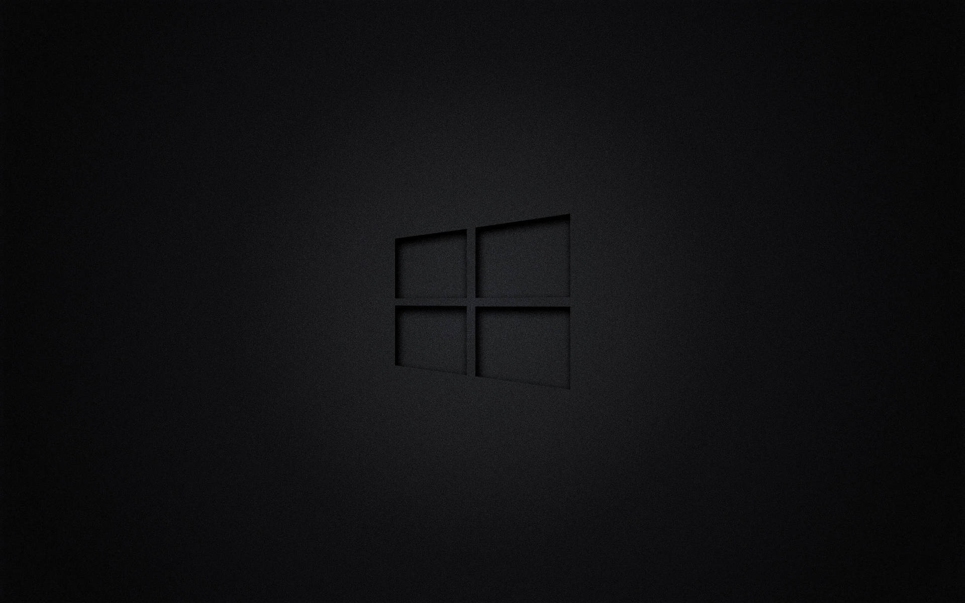 Windows標誌壓印在帶有紋理的深色表面上，柔和光線