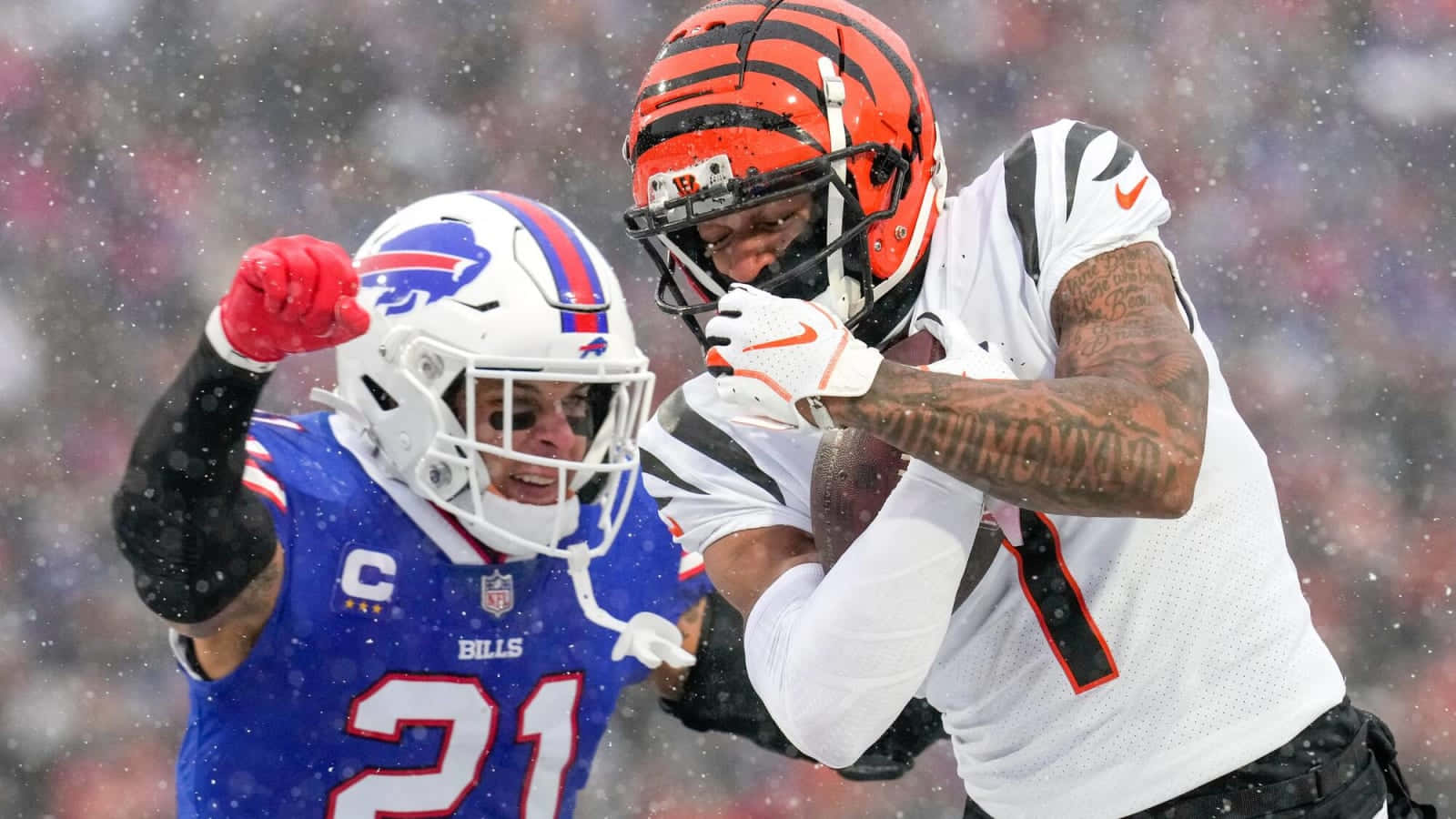 壁紙 — 辛辛那提猛虎隊球員在雪地NFL比賽中達陣，水牛城比爾隊防守球員在背景中反應。