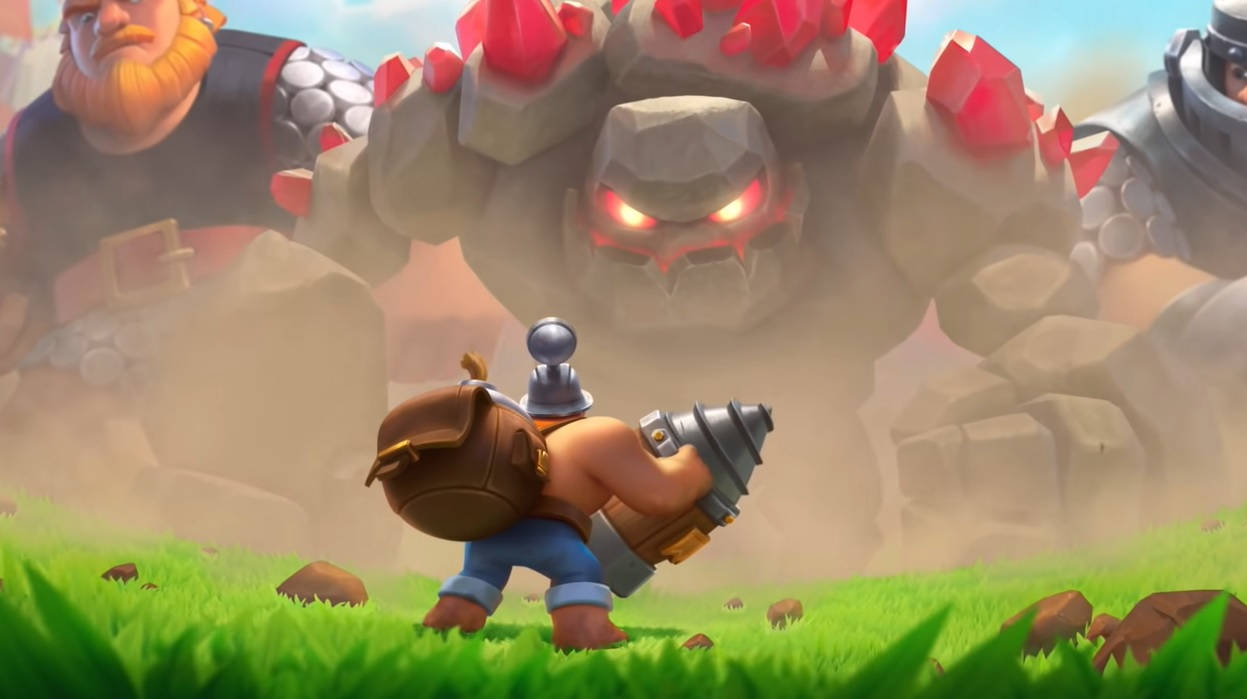 Clash Royale 巨石傀儡 壁紙 — 一個細小嘅裝甲戰士挑釁咁企喺草地上，面對住一個高聳憤怒、雙眼發紅光嘅石魔像。