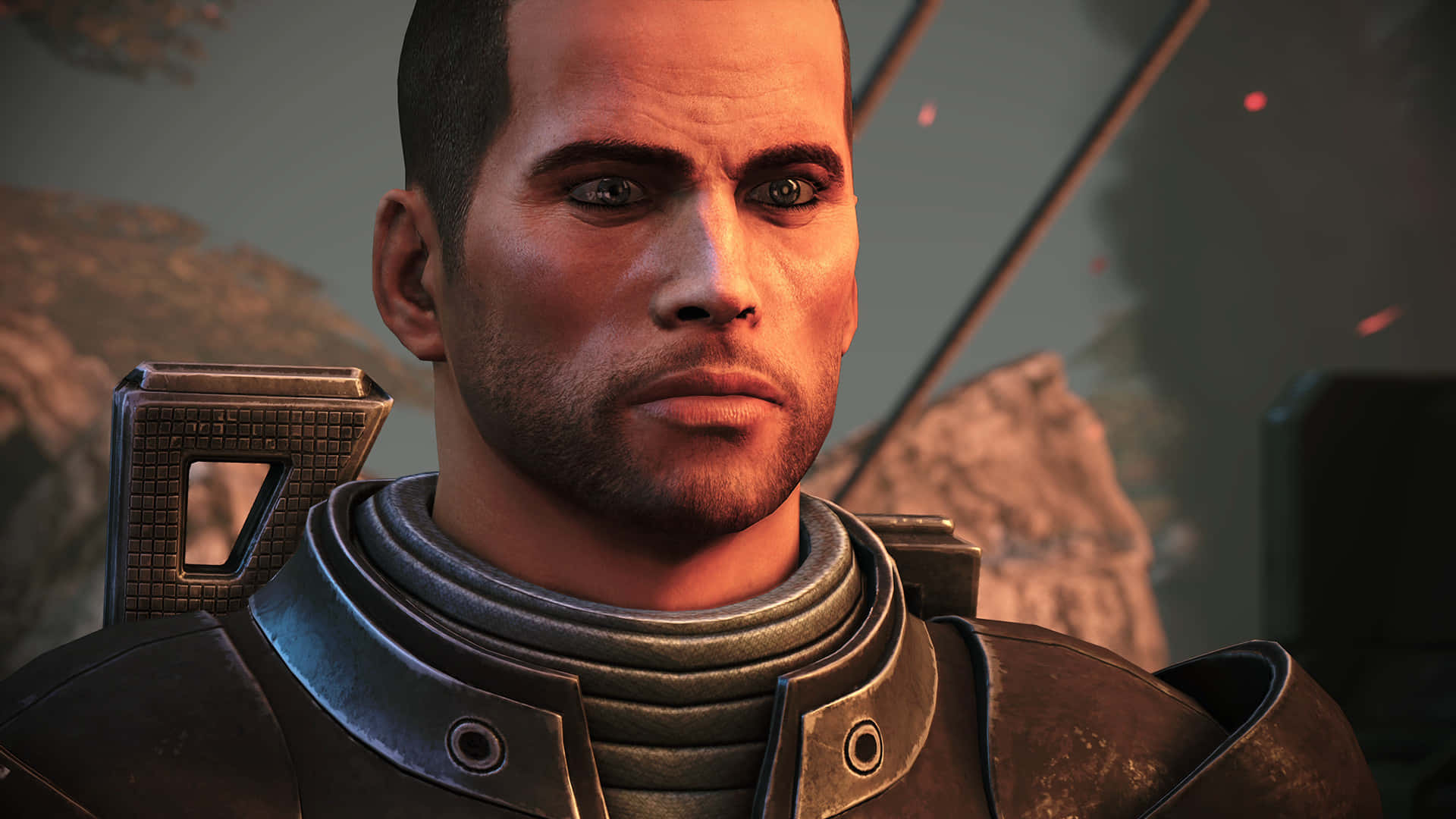 Mass Effect Legendary Edition 桌布 壁紙 — 身穿未來裝甲、表情嚴肅的士兵特寫，背景有岩石地形和發光的紅色粒子。