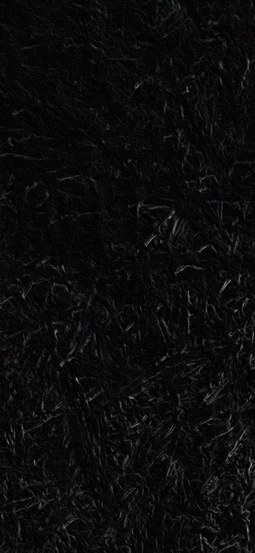 Black iPhone Xr 桌布 壁紙 — 密集黑色蓬鬆毛髮的特寫，帶有細微的灰色亮點，營造出柔軟的紋理表面。