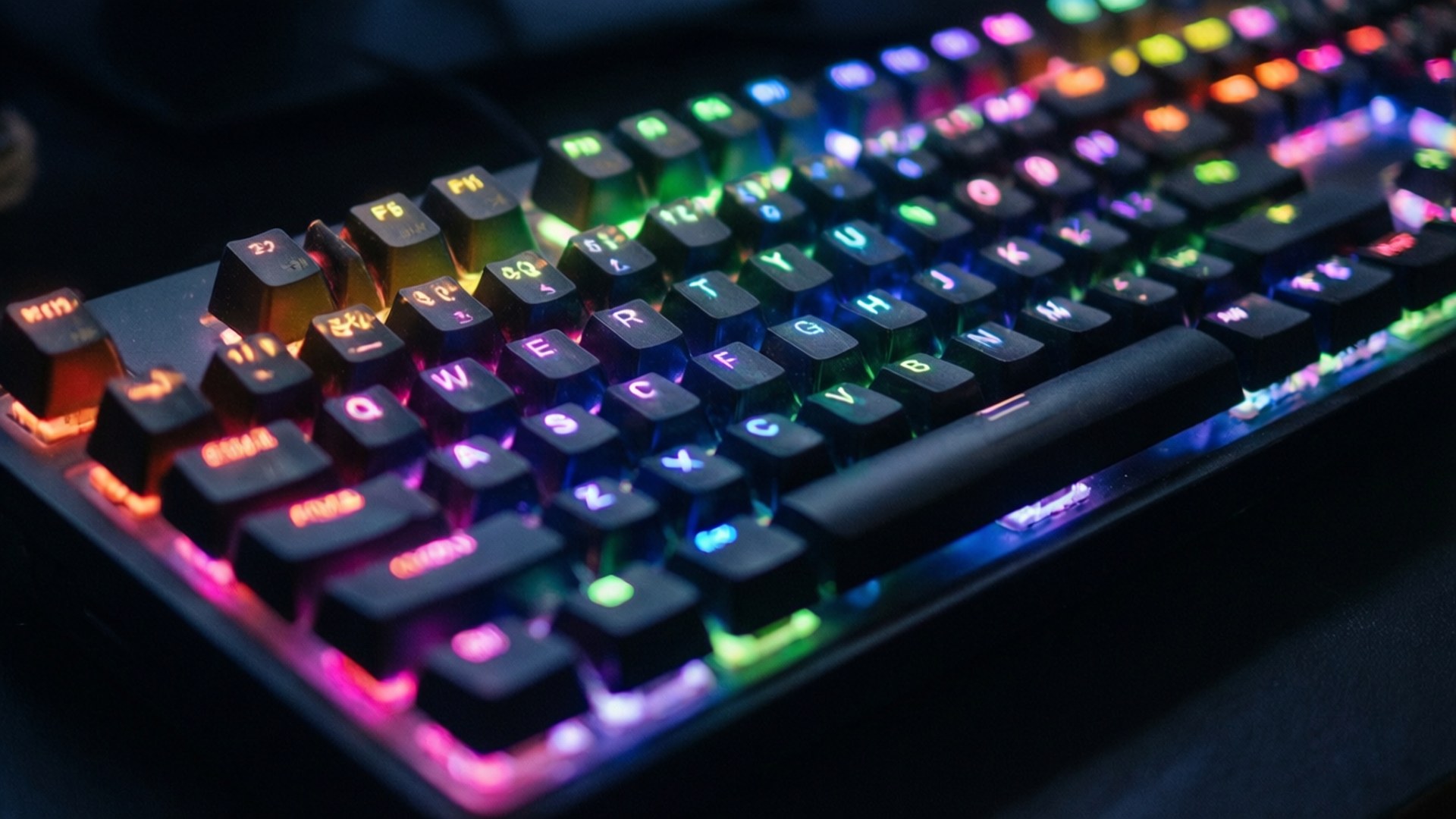 Neon Pc 桌布 壁紙 — 暗色背景上，一個發出鮮豔彩虹背光的電競鍵盤特寫。