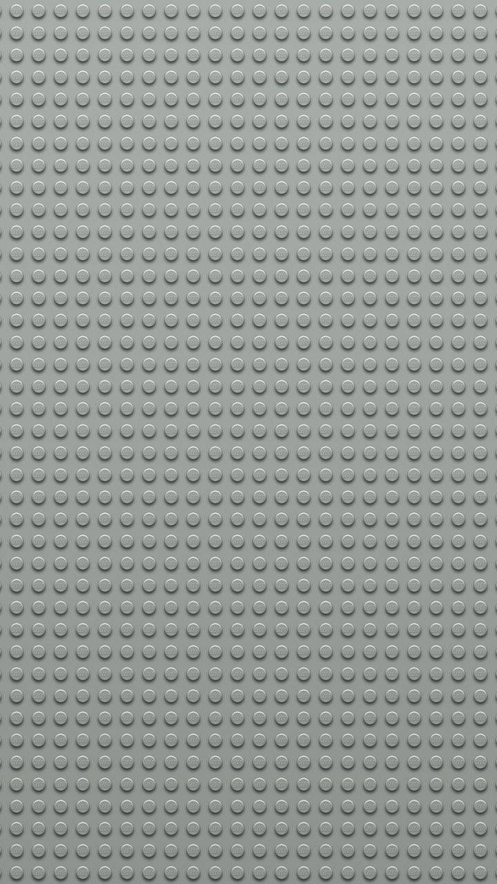 灰色LEGO底板，帶有重複的圓形凸點用於搭建。