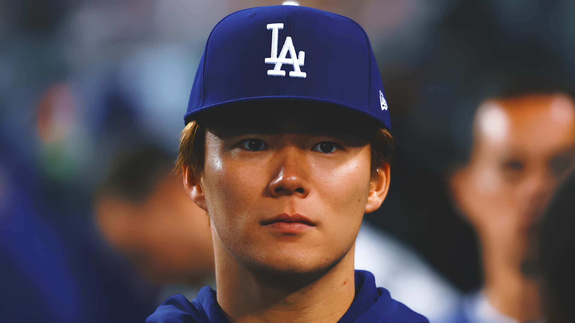  壁紙 — 專注的棒球運動員在球場燈光下戴著藍色LA Dodgers帽子的特寫肖像。