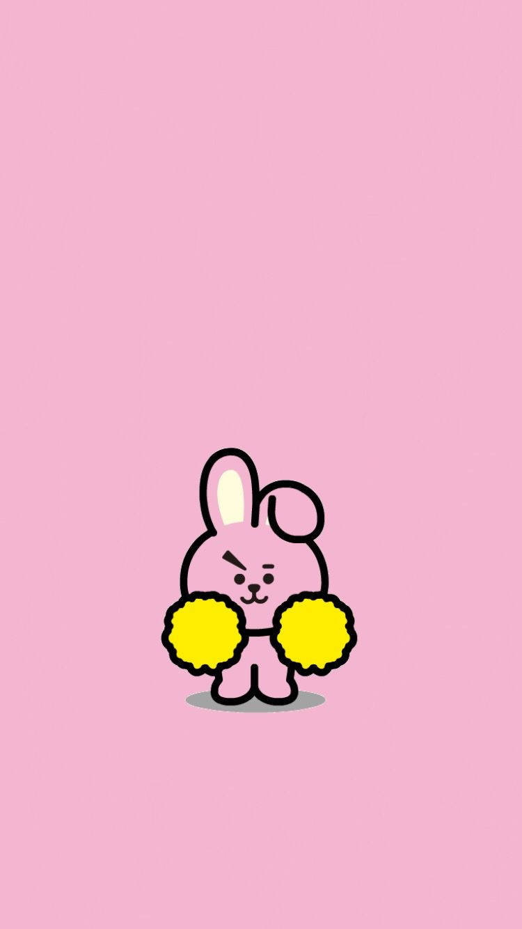 Cooky BT21 黃色絨球一對 壁紙 — 一隻可愛的粉紅色卡通兔子，帶有黑色輪廓，在純粉紅色背景上拿著黃色絨球。