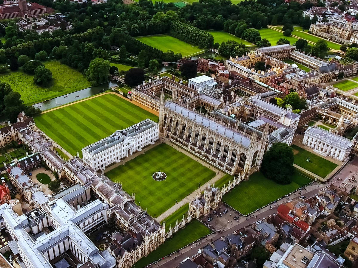 劍橋 Corpus Christi 學院 壁紙 — 歷史大學建築的鳥瞰圖，擁有修剪整齊的綠色草坪和蜿蜒的河流，周圍環繞著茂密的樹木。
