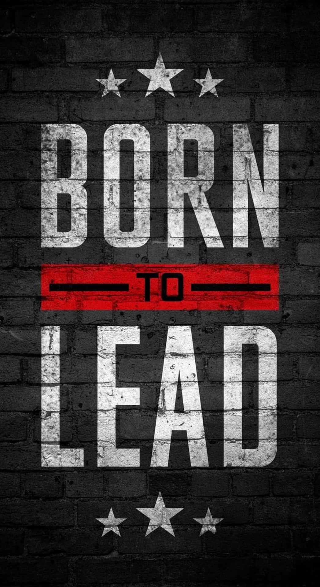  壁紙 — 粗獷黑色磚牆背景上帶有星星的粗體白色和紅色文字「BORN TO LEAD」。