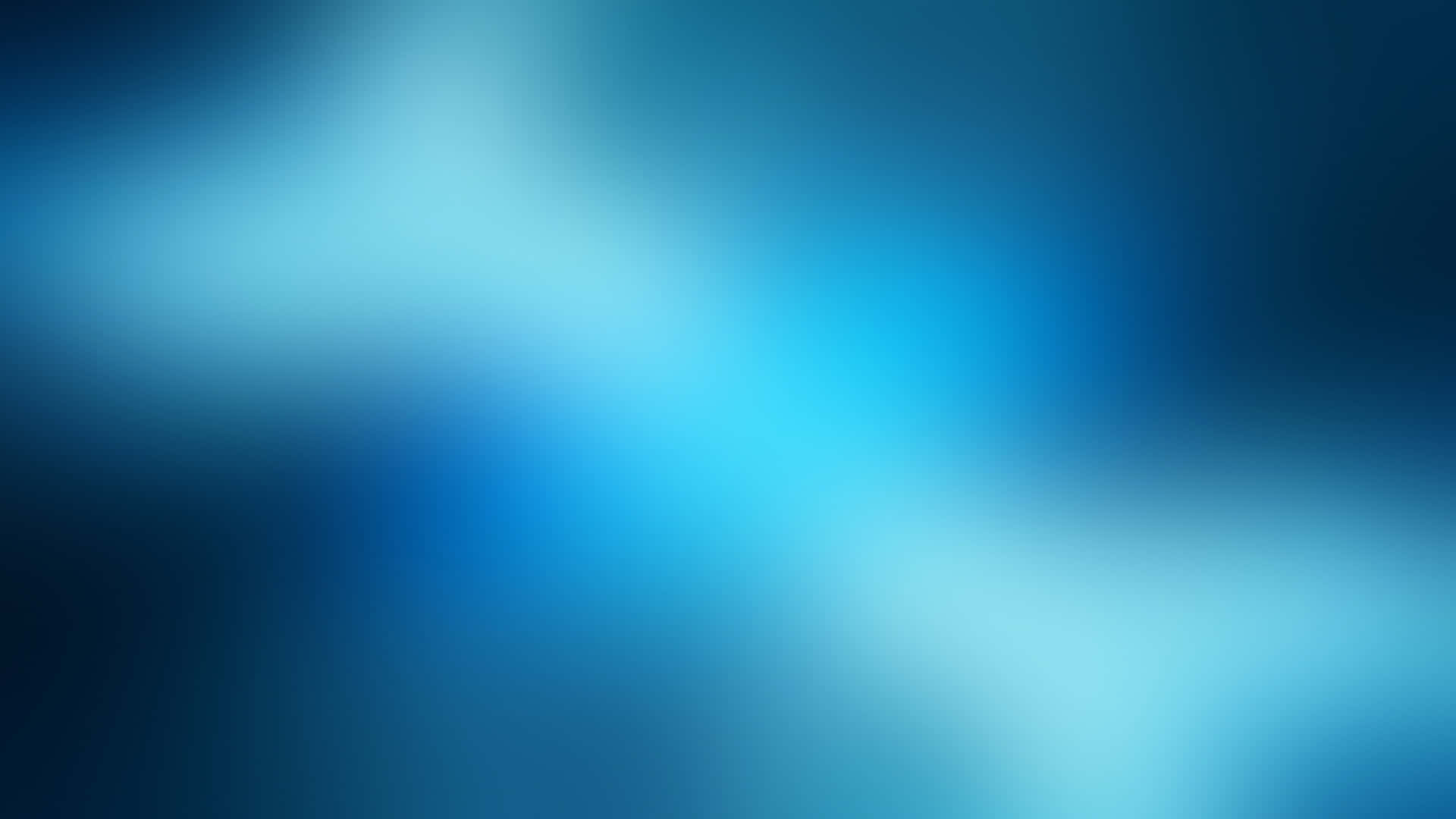 Vlogger為即將拍攝的影片做準備 壁紙 — 從深海軍藍到亮青色，冷色調藍色的柔和漸變，呈現流暢的抽象模糊效果。