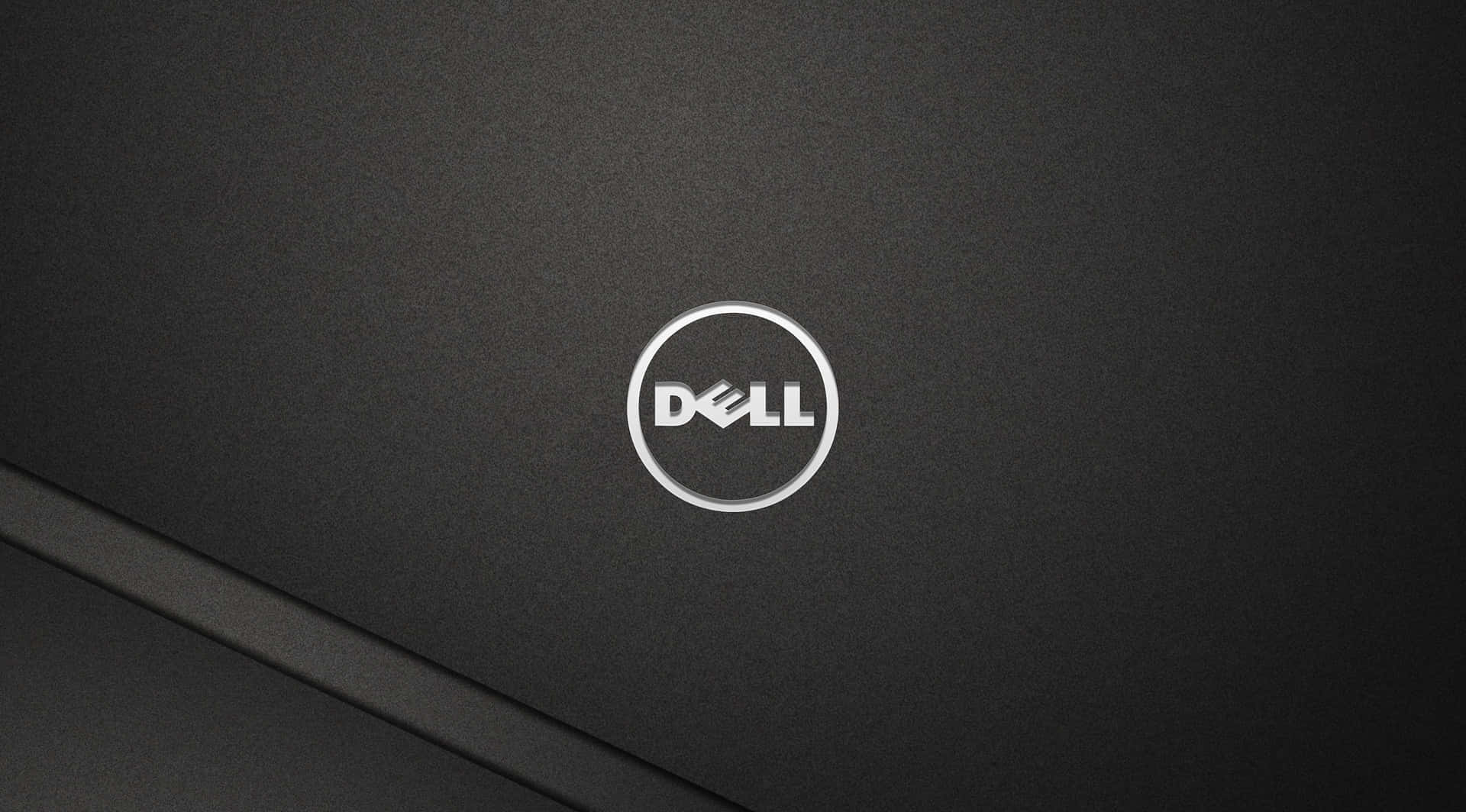Dell手提電腦蓋的近距離特寫，銀色標誌在黑色表面上。