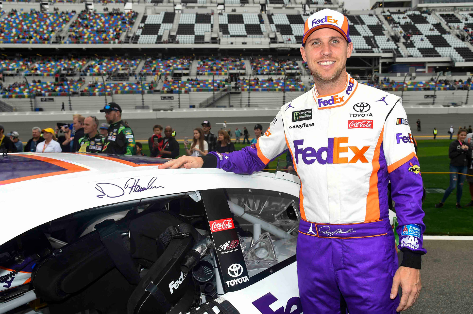 丹尼·哈姆林在NASCAR賽道上與他的FedEx Toyota賽車合影。