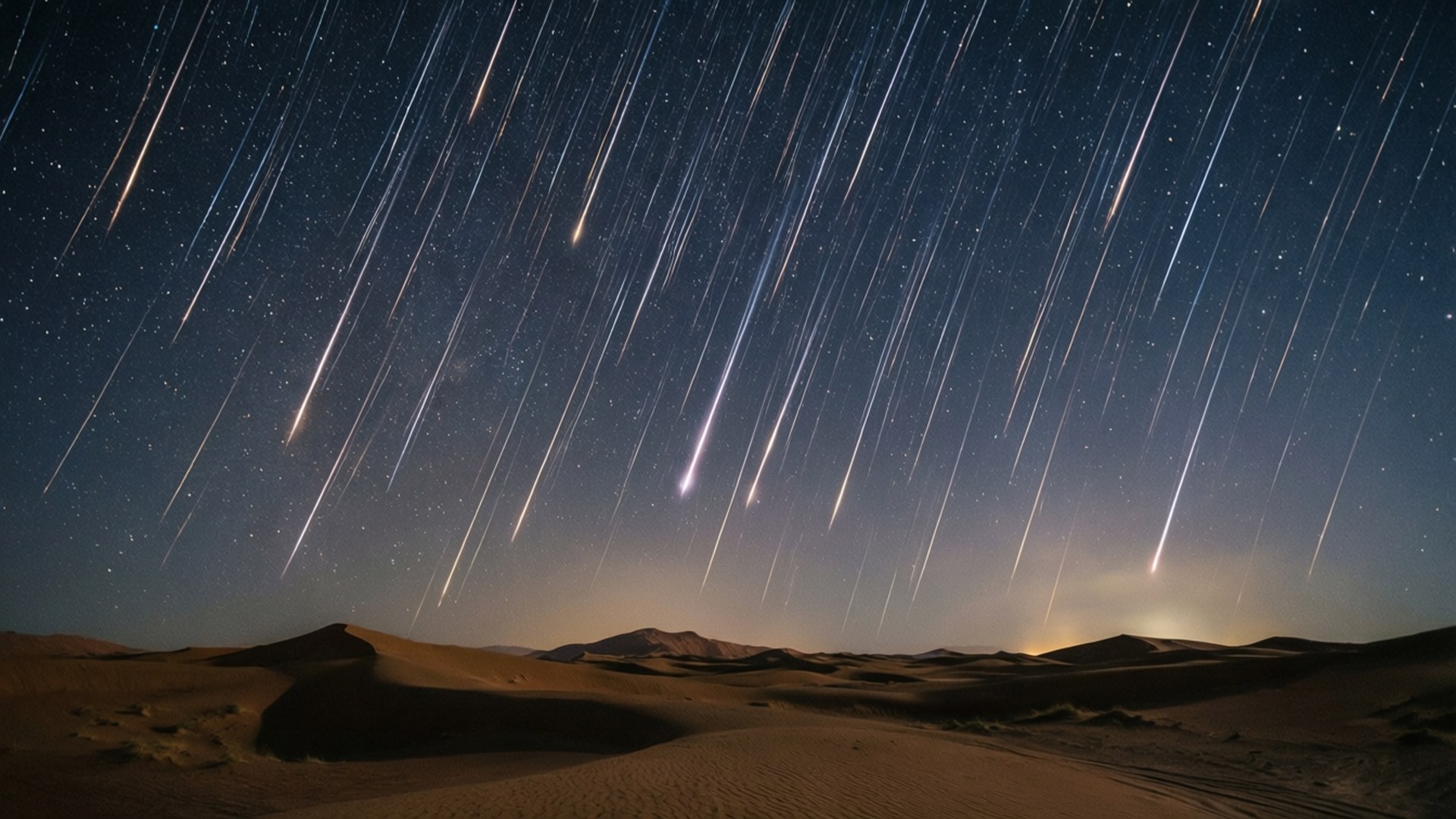 星軌在沙漠夜空中拱起，位於沙丘之上。