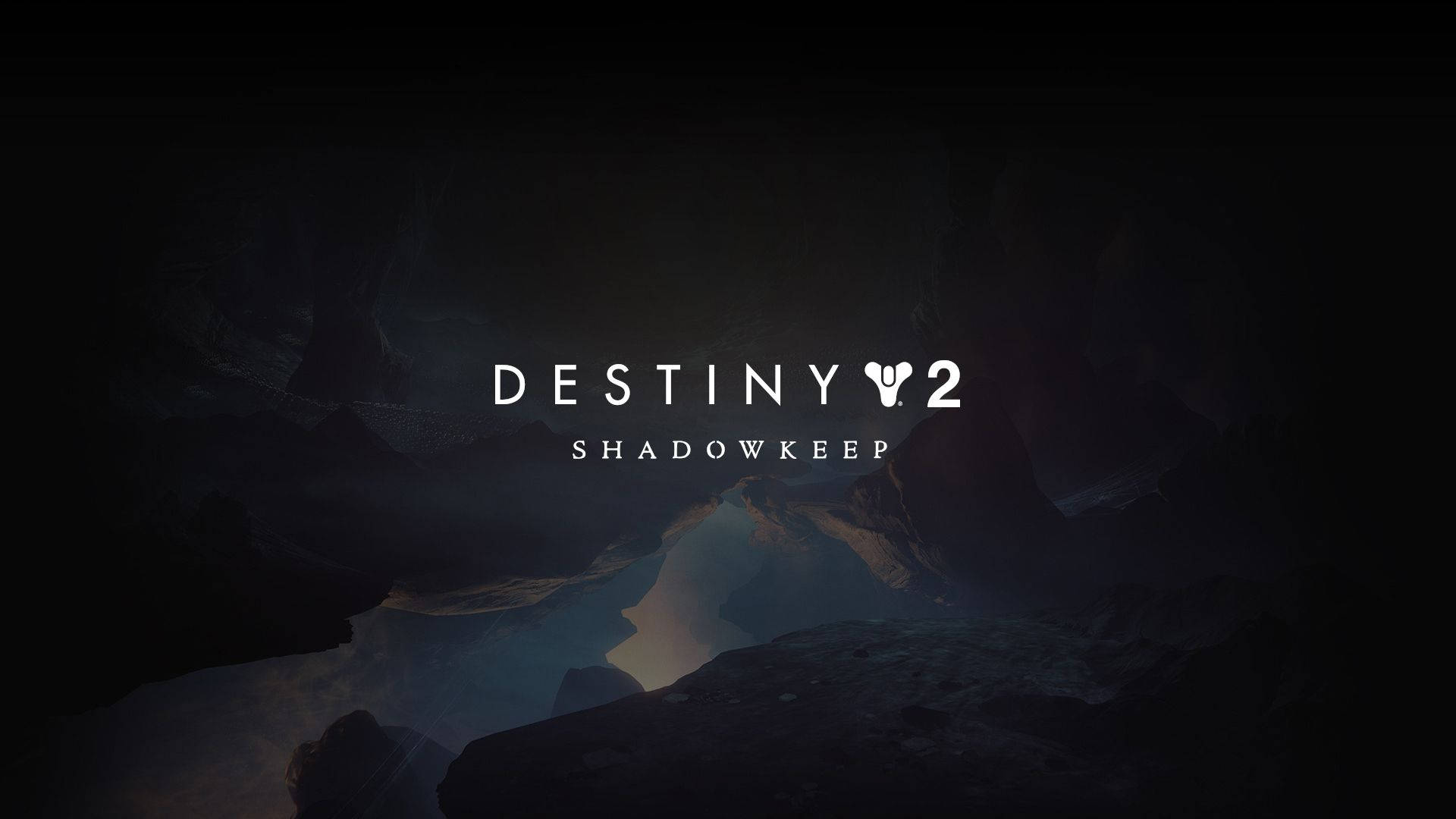《Destiny 2: Shadowkeep》月球景觀 壁紙 — 黑暗洞穴般的空間，藍色發光燈光照亮岩石 formations，Destiny 2 Shadowkeep 標題居中白色。