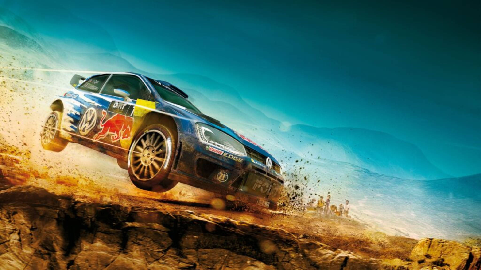 Dirt 3 保時捷賽車 壁紙 — 一輛帶有Red Bull塗裝的藍色拉力賽車在岩石沙漠懸崖上飛躍，在充滿活力的藍天下揚起灰塵。