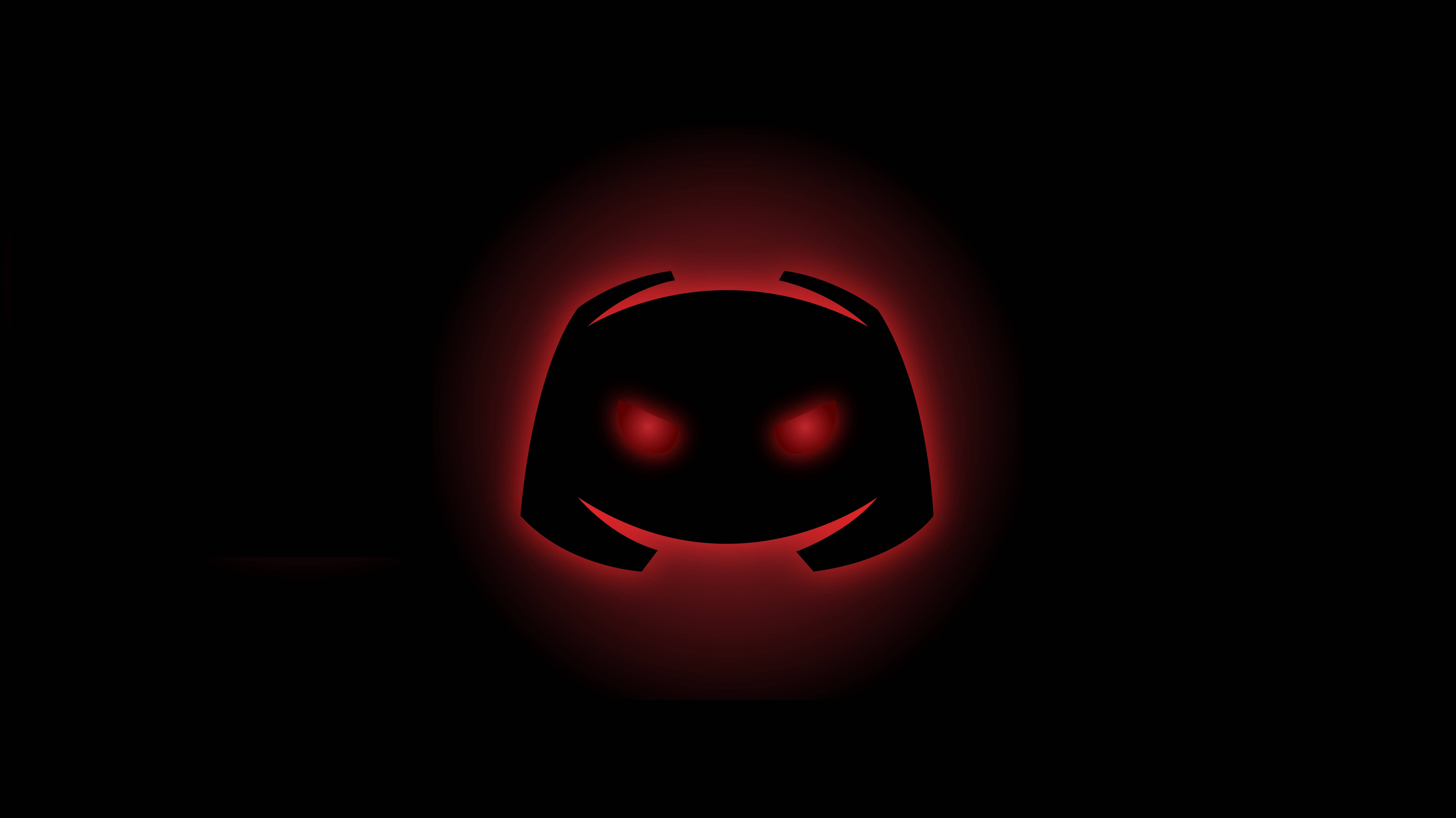 Discord 邪惡 Clyde 壁紙 — 一個發光的紅色Discord標誌，帶有發光的眼睛，在黑色背景上脈動。