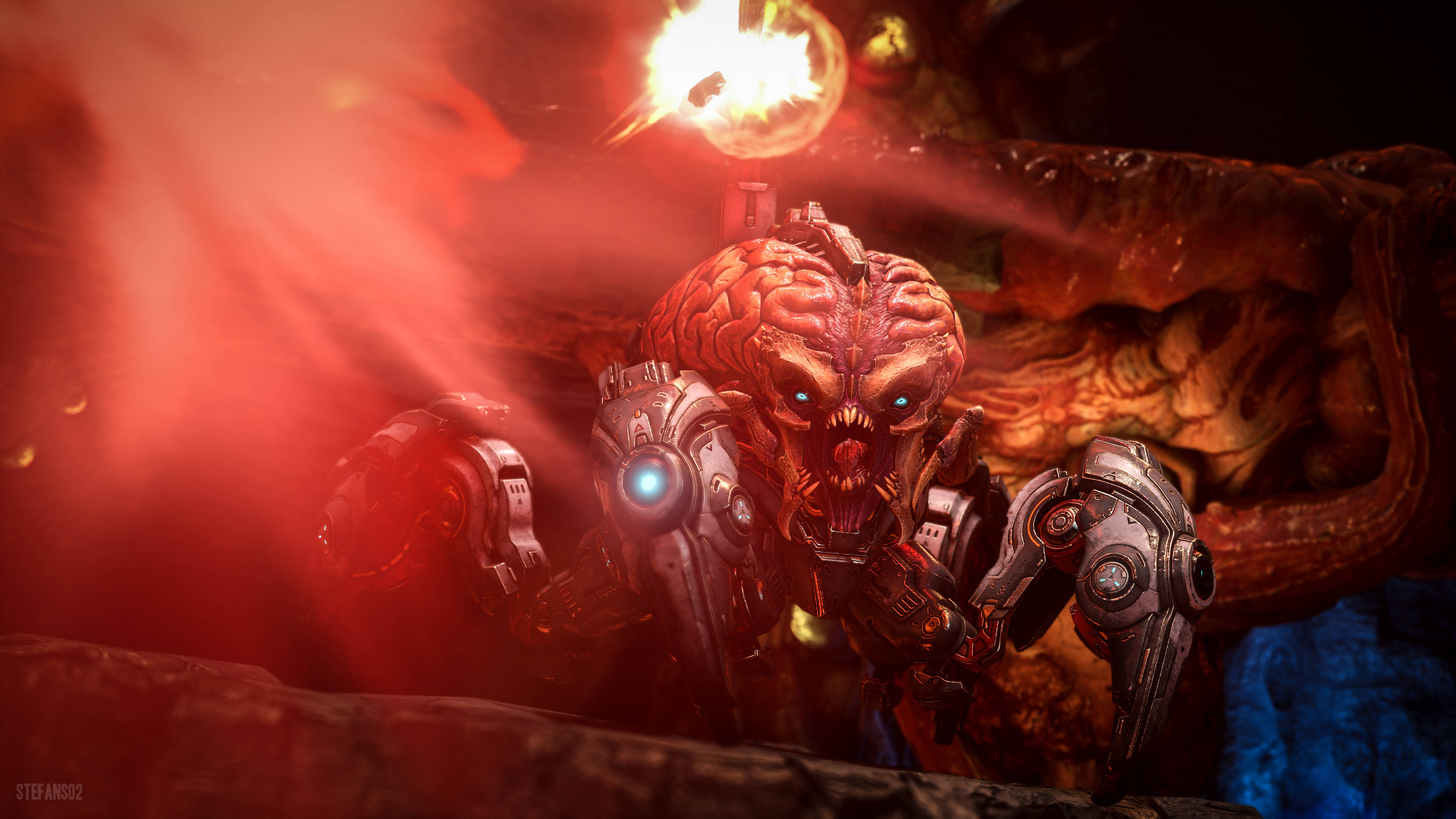 探索《Doom Eternal》中的核爆荒原 壁紙 — 一個擁有發光藍色眼睛和類似大腦頭部的生物機械怪物在火紅煙霧和熔岩中咆哮。