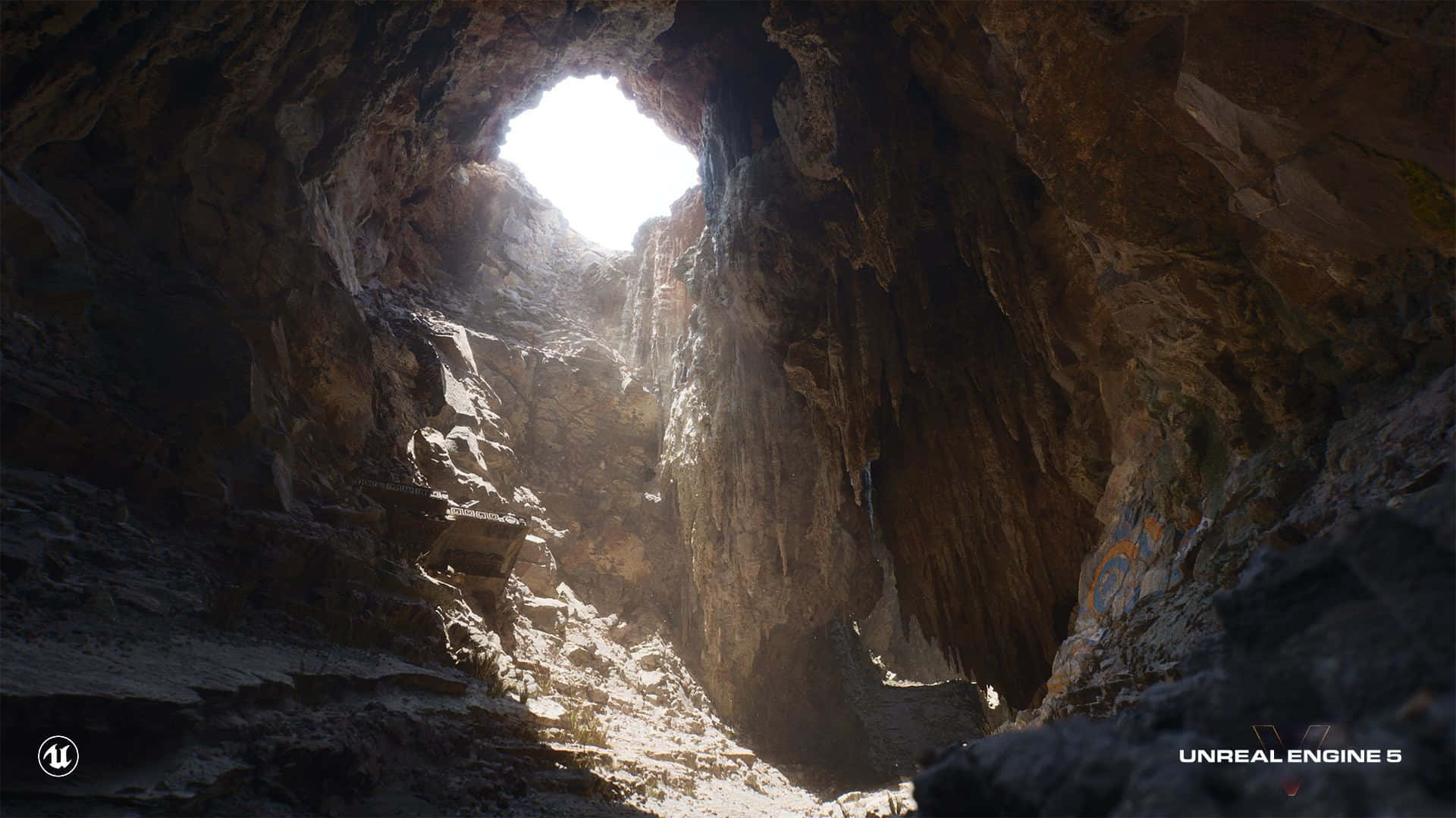  壁紙 — 從崎嶇洞穴內部向上看的戲劇性景色，陽光從高處開口射入，照亮了紋理豐富的岩壁。